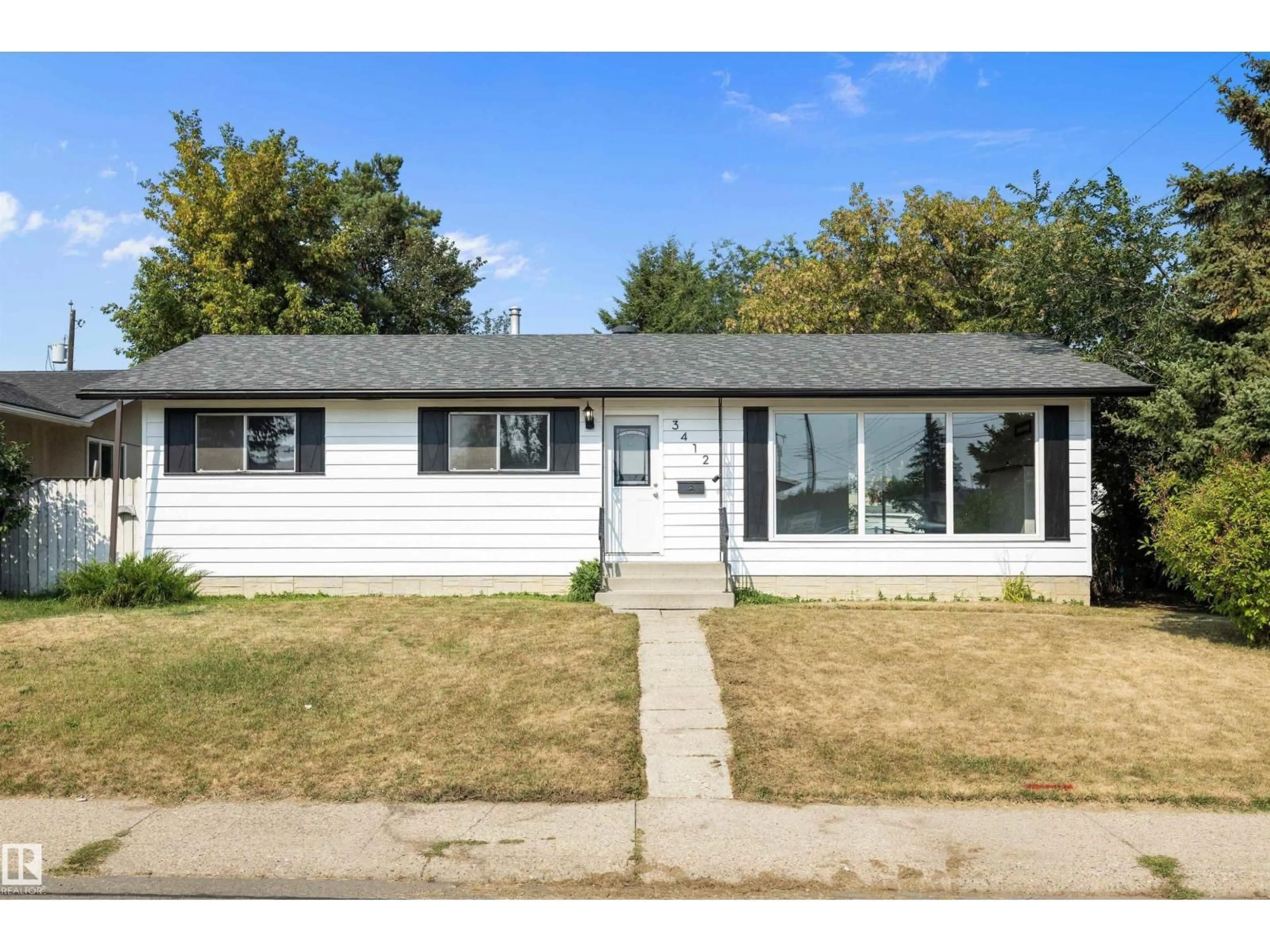 Home with vinyl exterior material, street for 3412 114 AV, Edmonton Alberta T5W0S3