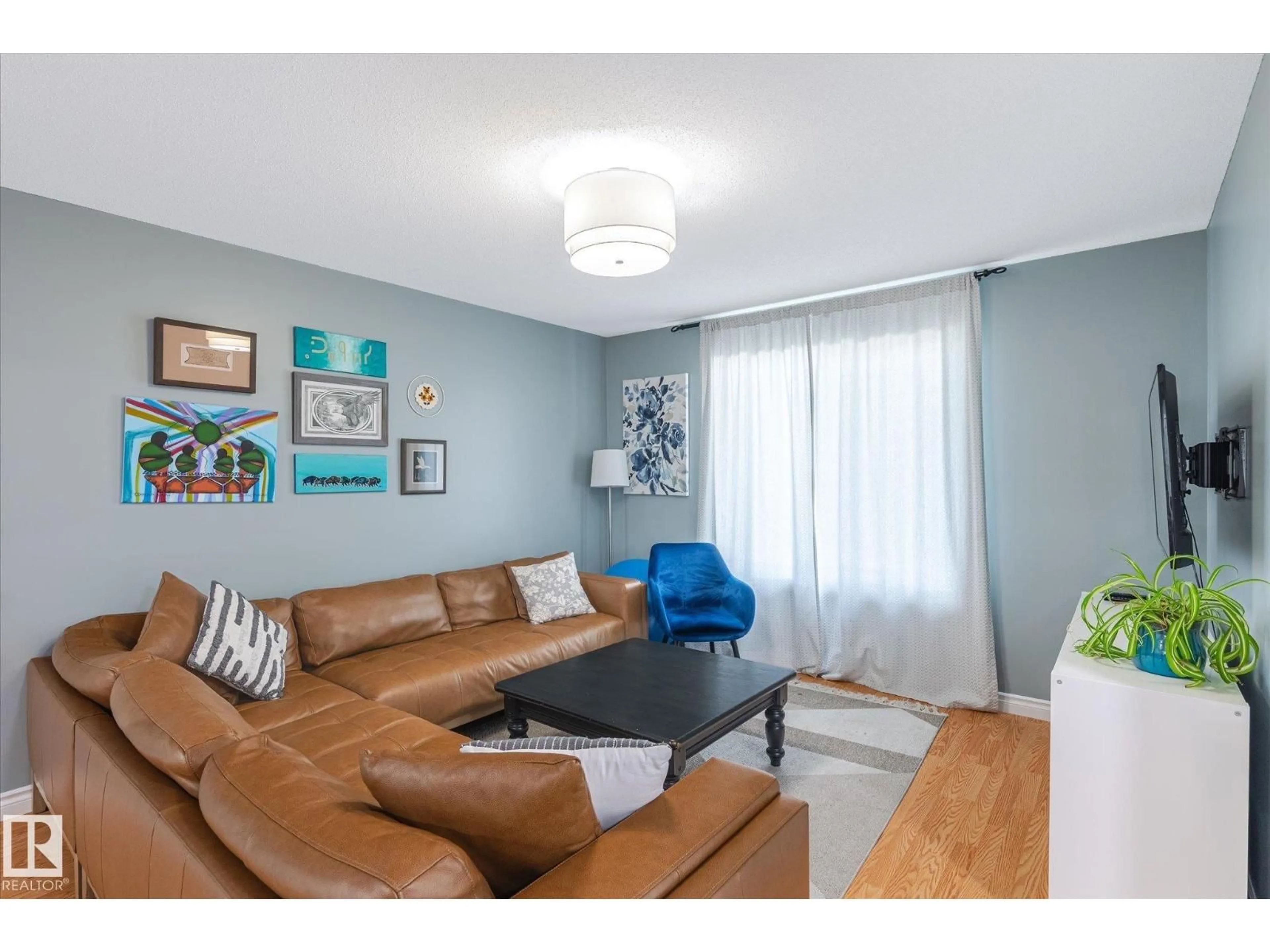Living room with furniture, wood/laminate floor for NW - 12727 123A ST, Edmonton Alberta T5L0K6