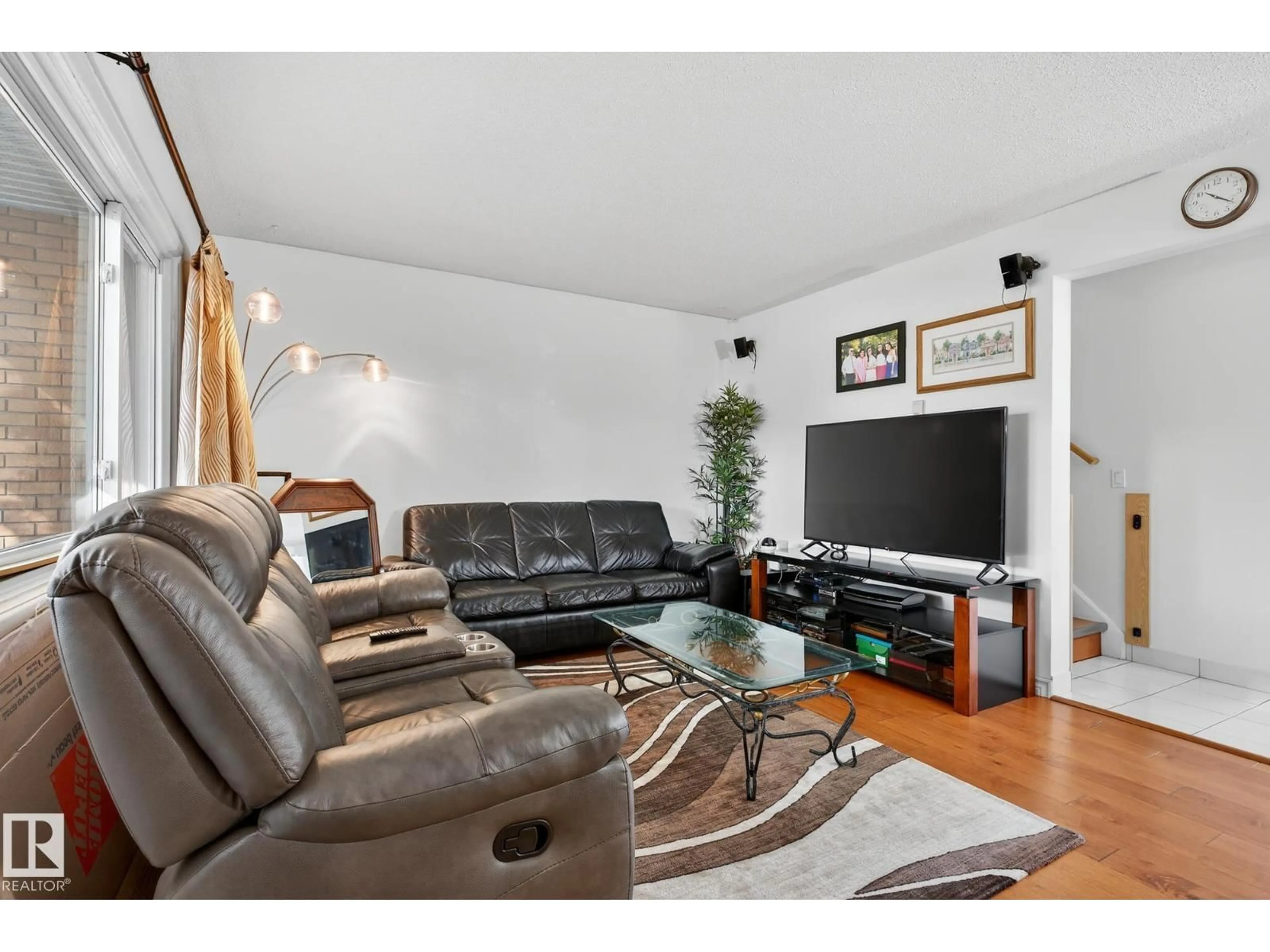 Living room with furniture, wood/laminate floor for 5741 144 AV, Edmonton Alberta T5A1K6