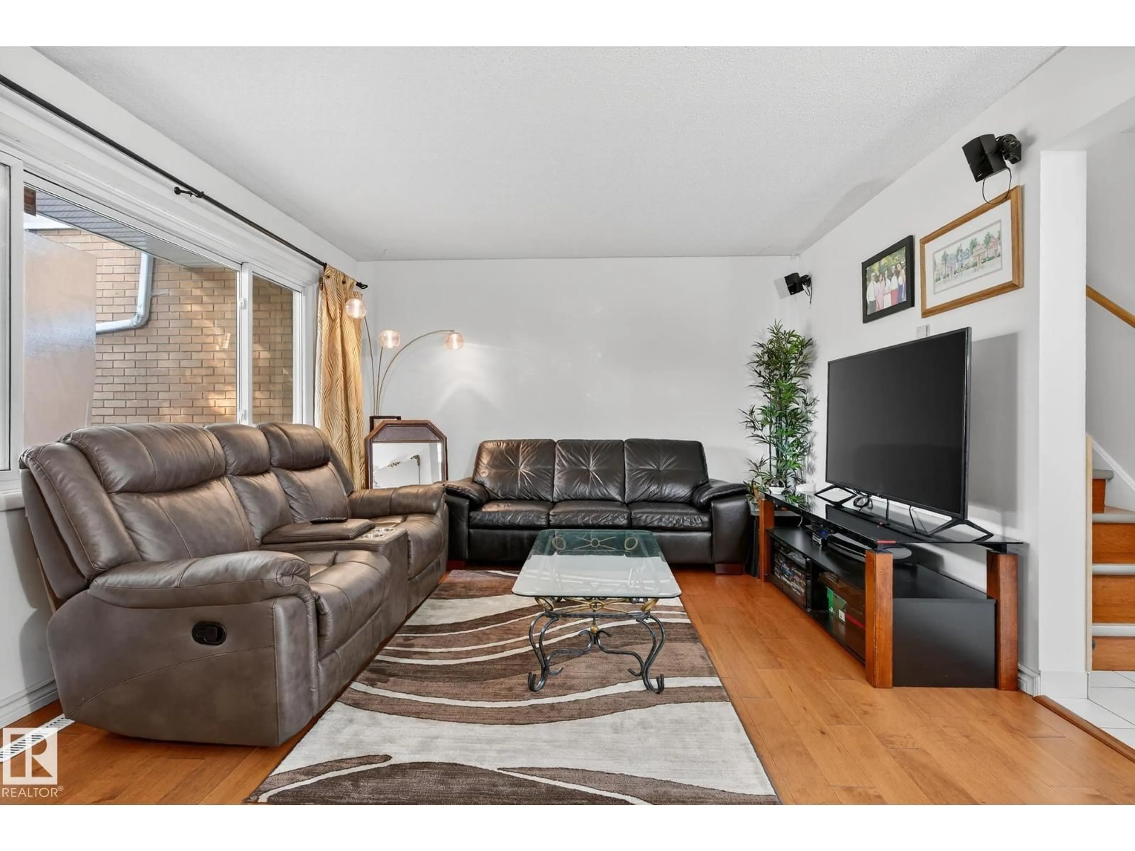 Living room with furniture, wood/laminate floor for 5741 144 AV, Edmonton Alberta T5A1K6