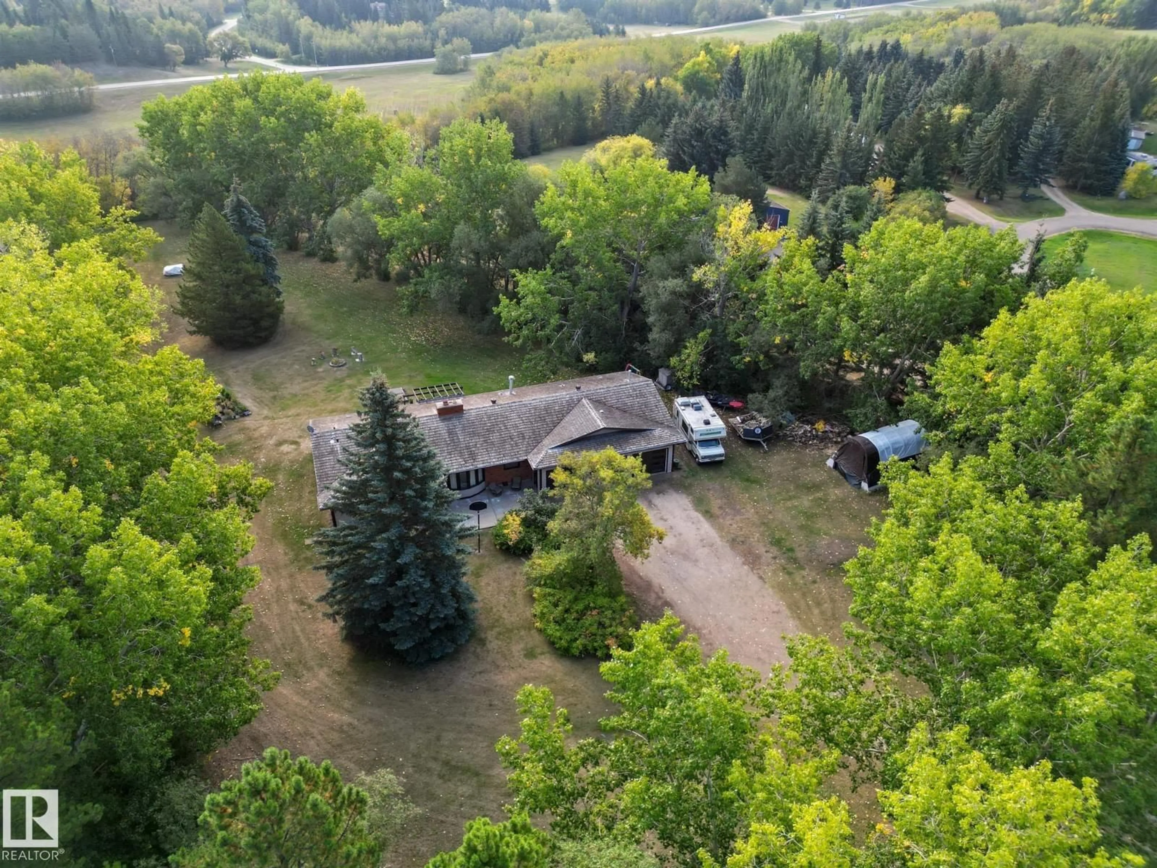 A pic from outside/outdoor area/front of a property/back of a property/a pic from drone, forest/trees view for #103 - 24213 TWP ROAD 554, Rural Sturgeon County Alberta T8T1X9