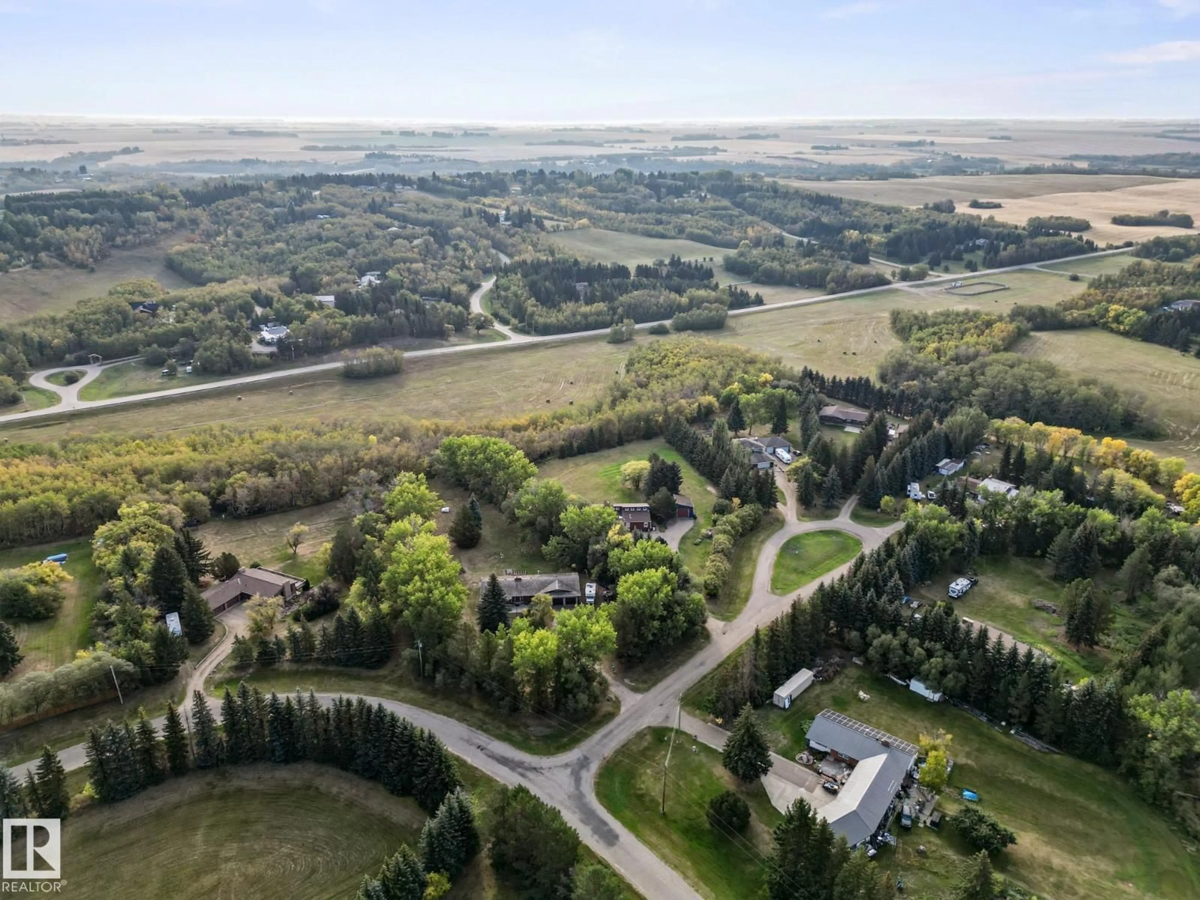 A pic from outside/outdoor area/front of a property/back of a property/a pic from drone, mountain view for #103 - 24213 TWP ROAD 554, Rural Sturgeon County Alberta T8T1X9