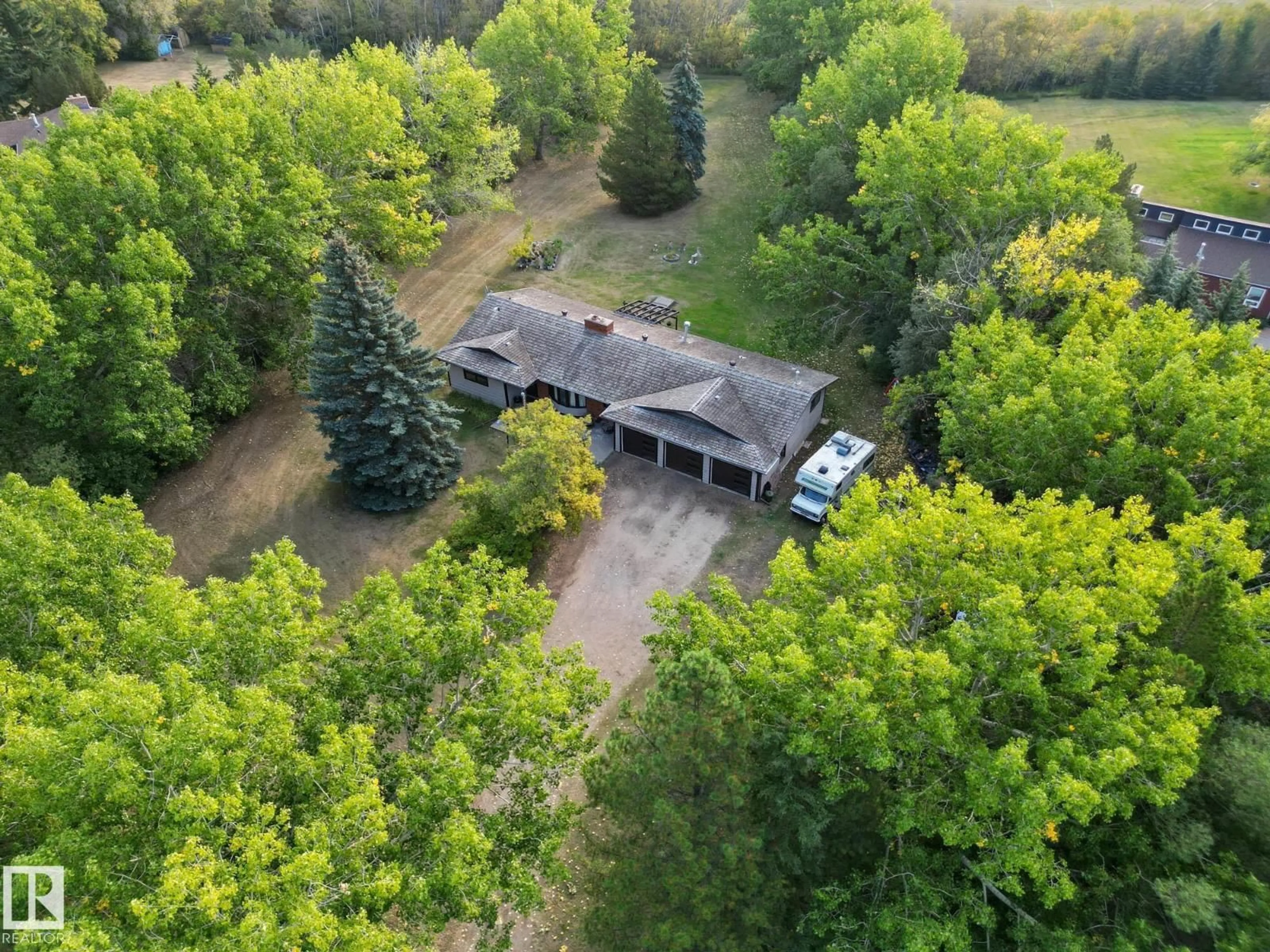 A pic from outside/outdoor area/front of a property/back of a property/a pic from drone, forest/trees view for #103 - 24213 TWP ROAD 554, Rural Sturgeon County Alberta T8T1X9