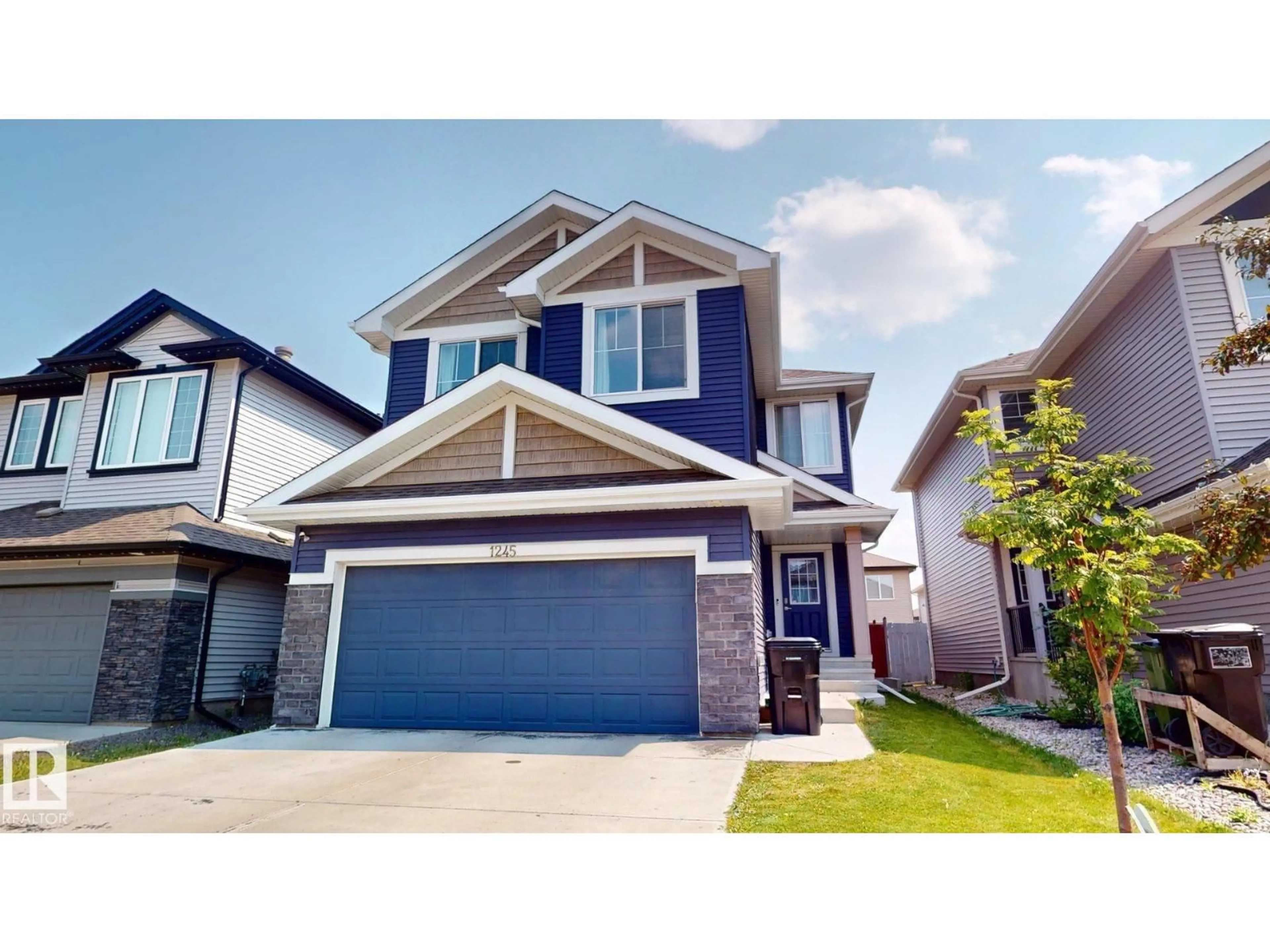 Home with vinyl exterior material, street for NW - 1245 26A ST, Edmonton Alberta T6T2J4