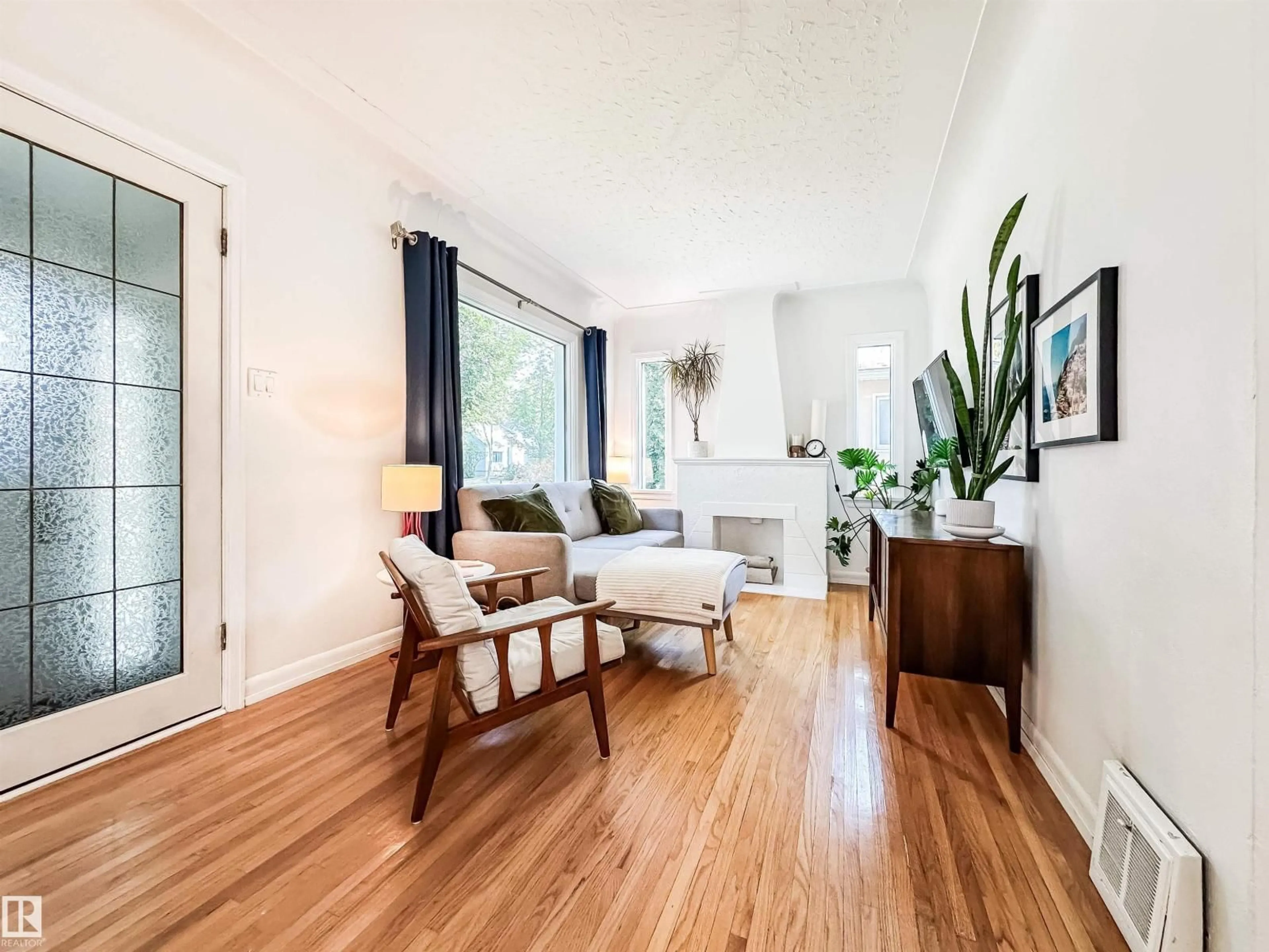 Living room with furniture, wood/laminate floor for 10807 63 AV, Edmonton Alberta T6H1P9