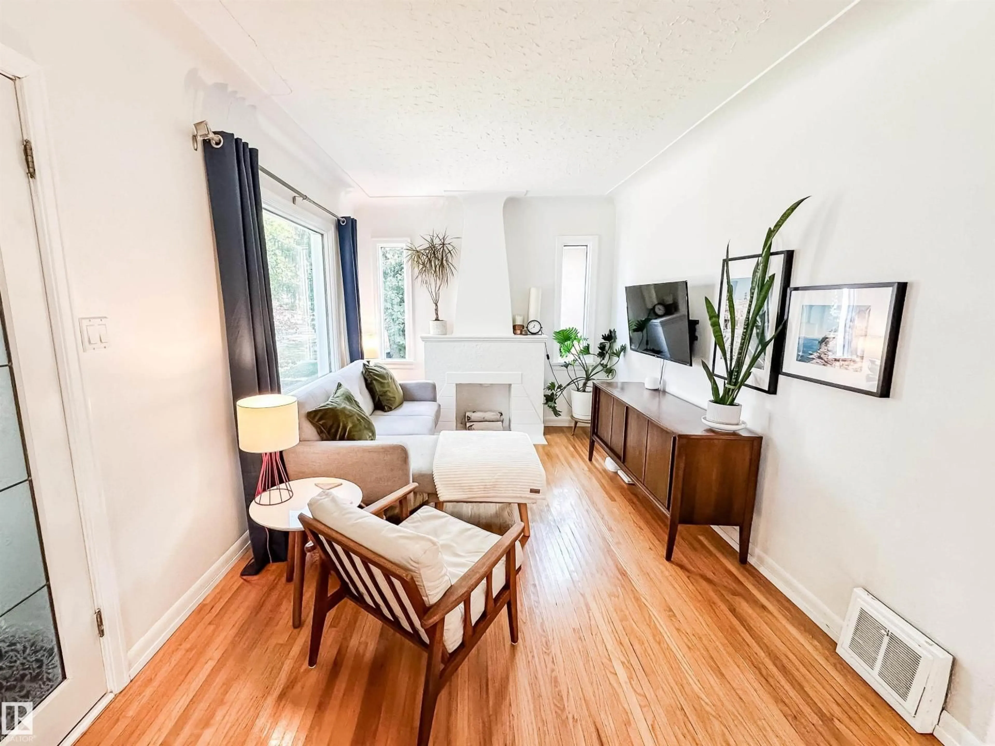 Living room with furniture, wood/laminate floor for 10807 63 AV, Edmonton Alberta T6H1P9
