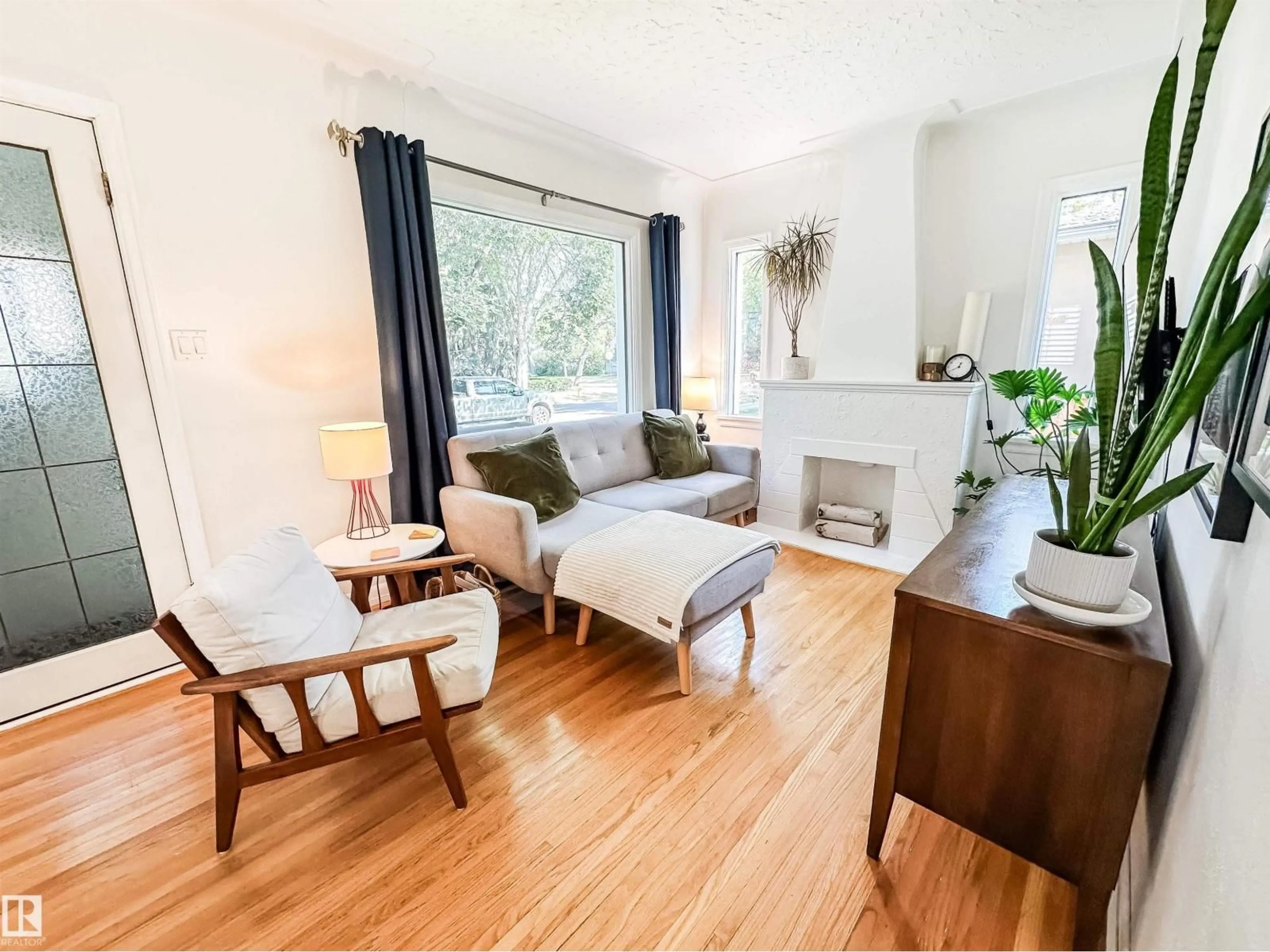 Living room with furniture, wood/laminate floor for 10807 63 AV, Edmonton Alberta T6H1P9