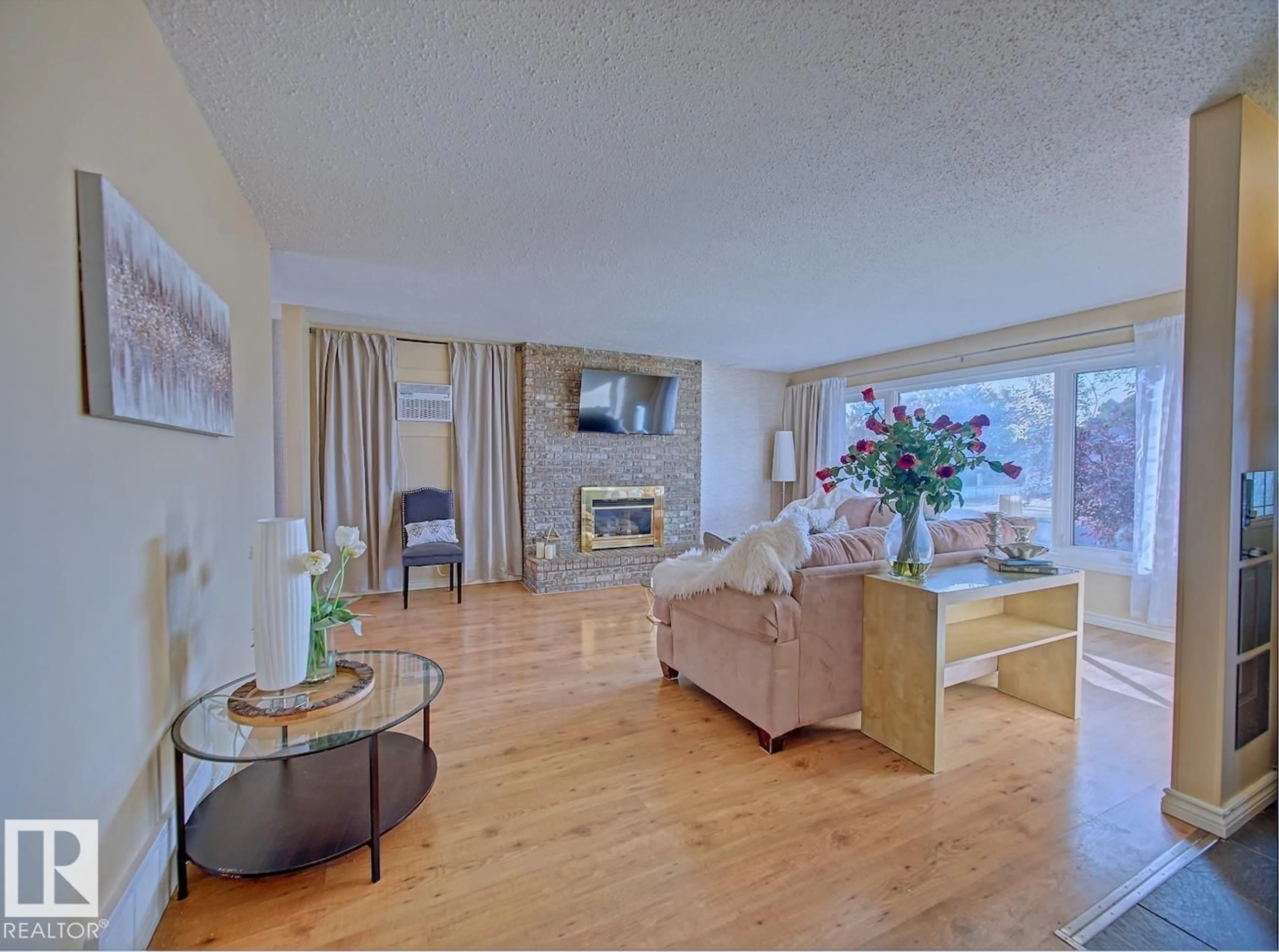 Living room with furniture, wood/laminate floor for 8268 94 AV, Fort Saskatchewan Alberta T8L2V2