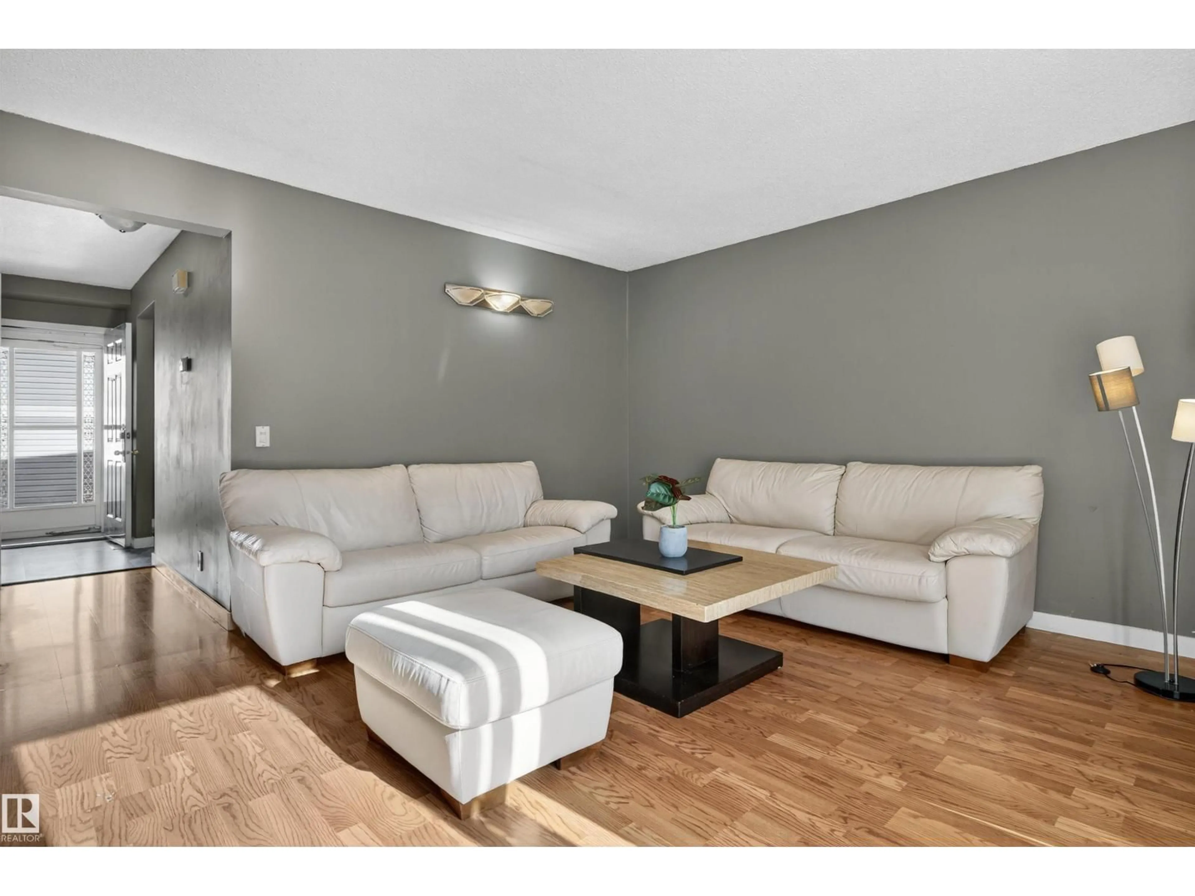 Living room with furniture, wood/laminate floor for 14017 121 ST, Edmonton Alberta T5X4H8