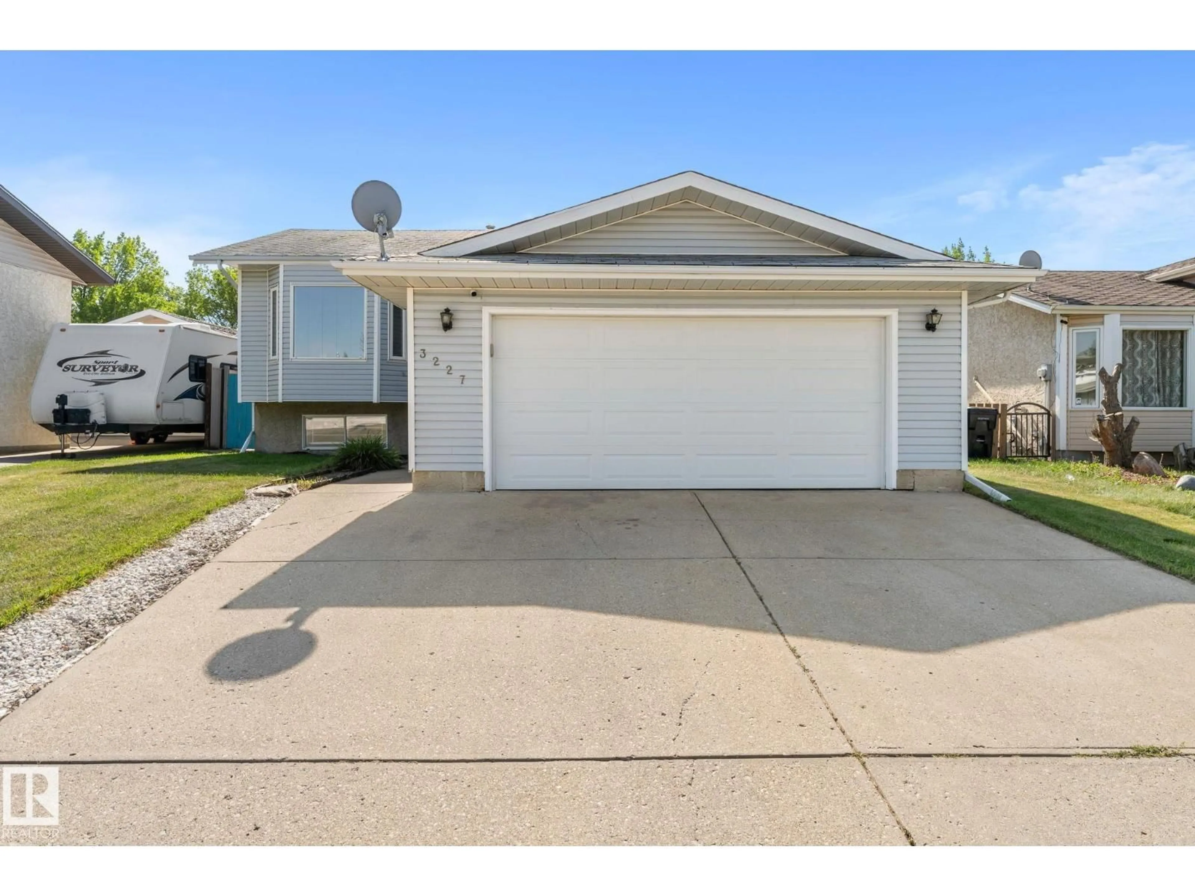 Home with vinyl exterior material, street for 3227 145 AV, Edmonton Alberta T5Y2E9