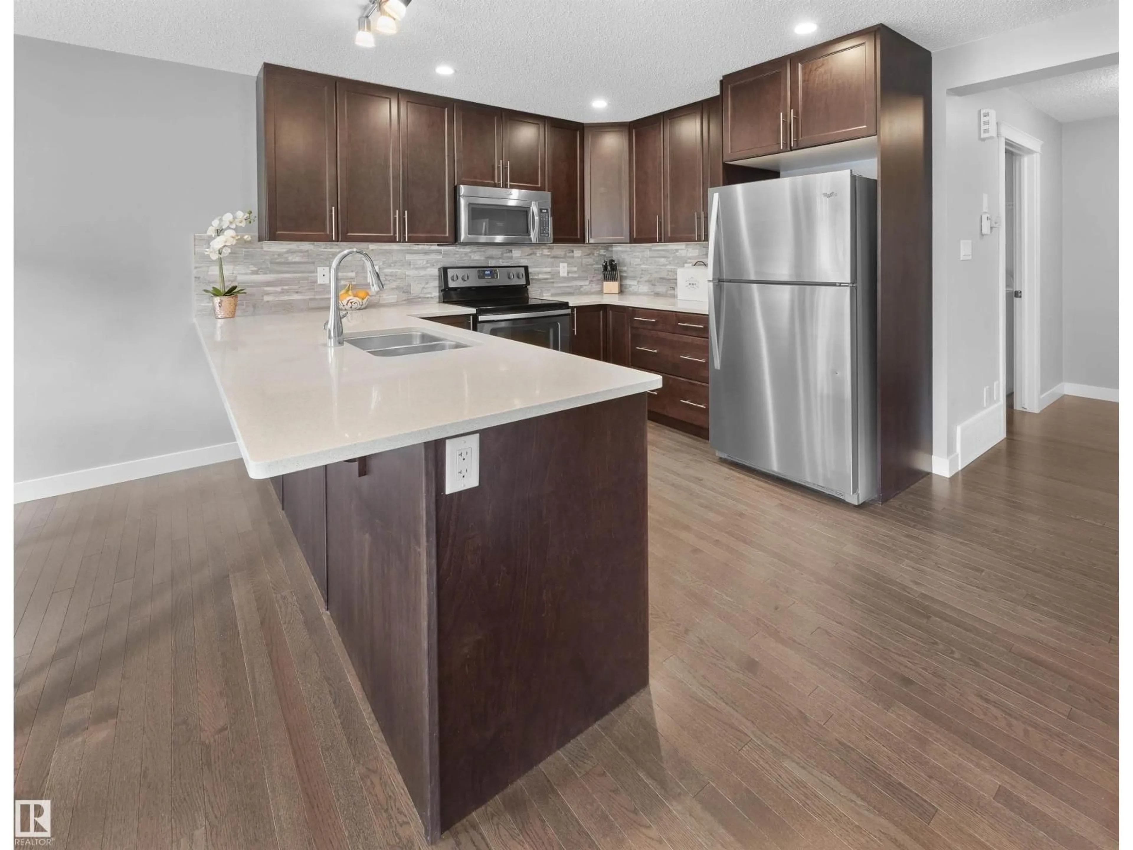 Open concept kitchen, wood/laminate floor for 1521 GRAYDON HILL PT, Edmonton Alberta T6W3C7