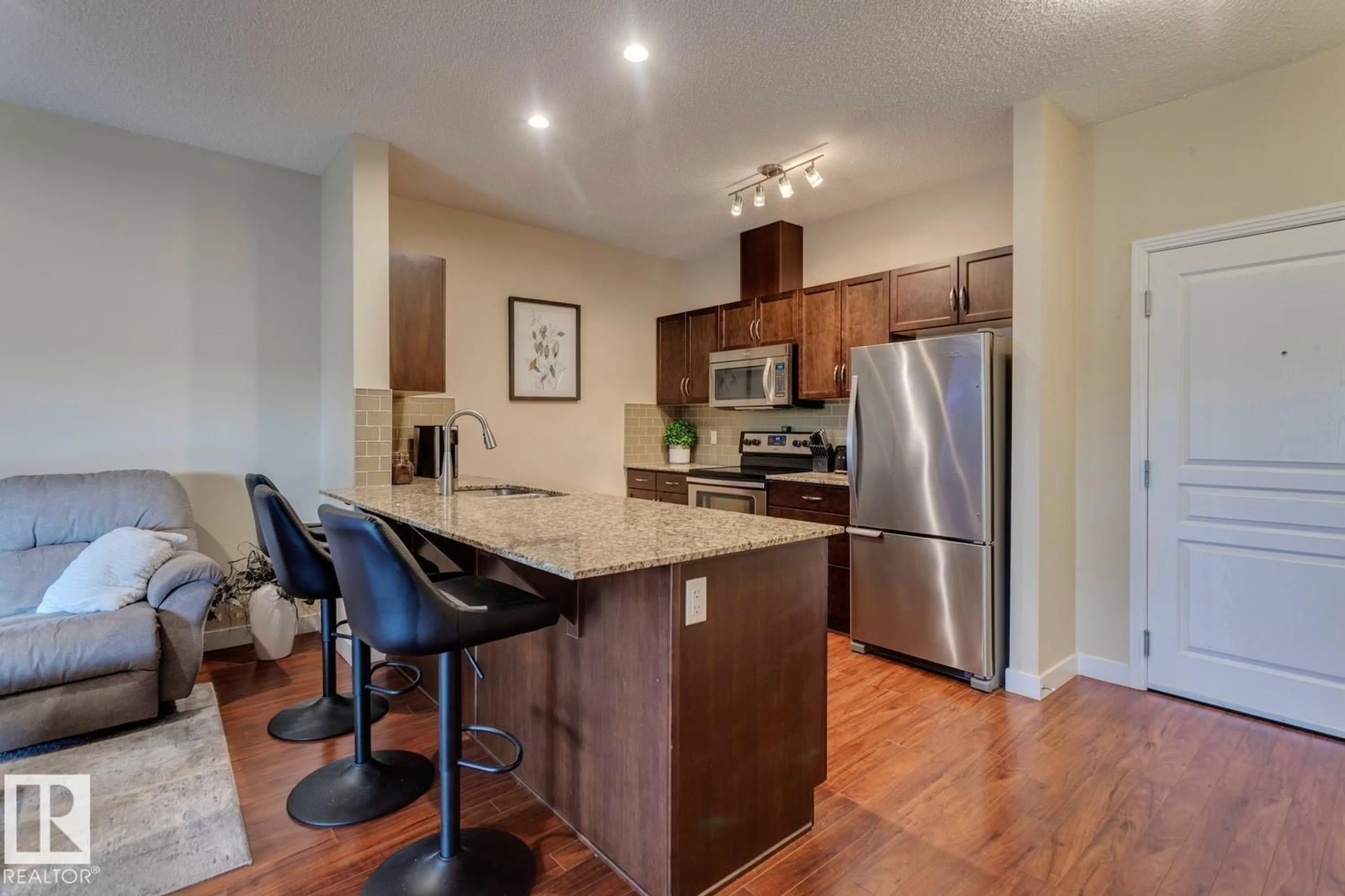 Open concept kitchen, wood/laminate floor for #426 - 2045 GRANTHAM CT, Edmonton Alberta T5T3X6