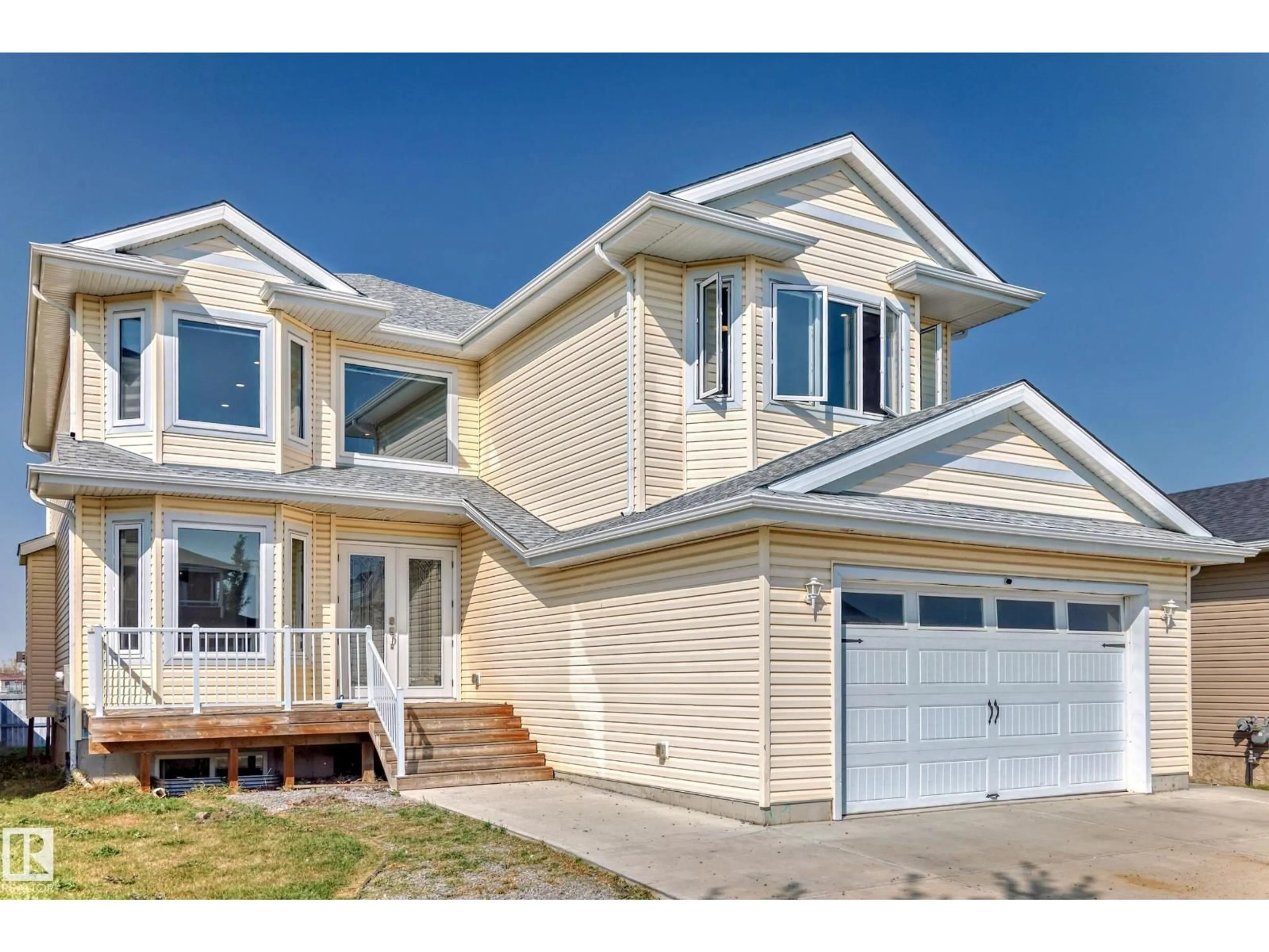 Home with vinyl exterior material, street for 128 HOULE DR, Morinville Alberta T8R0E1