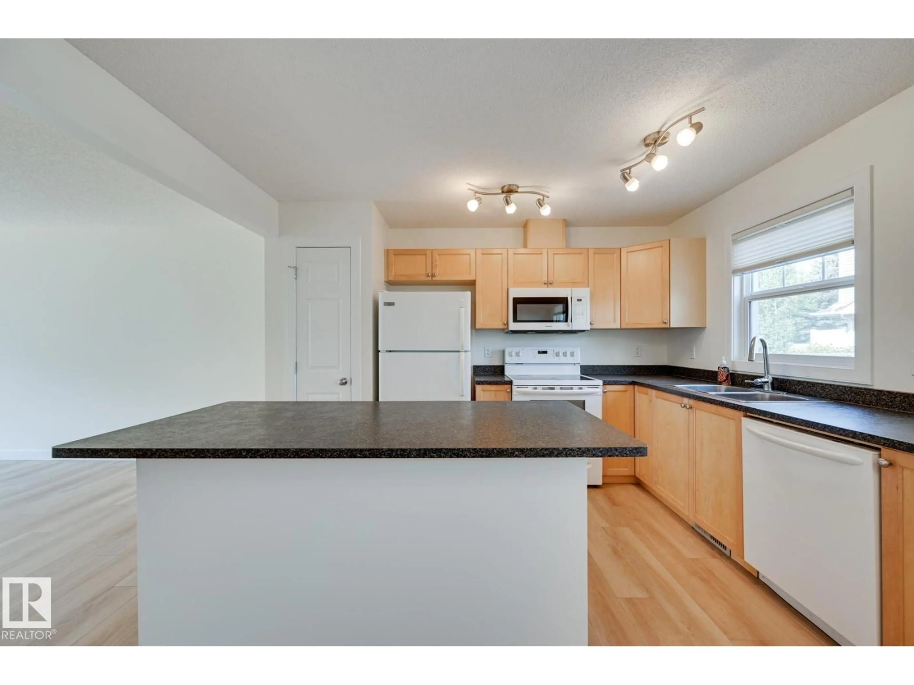 Open concept kitchen, wood/laminate floor for 38 - 6032 38 AV NW, Edmonton Alberta T6L0A4