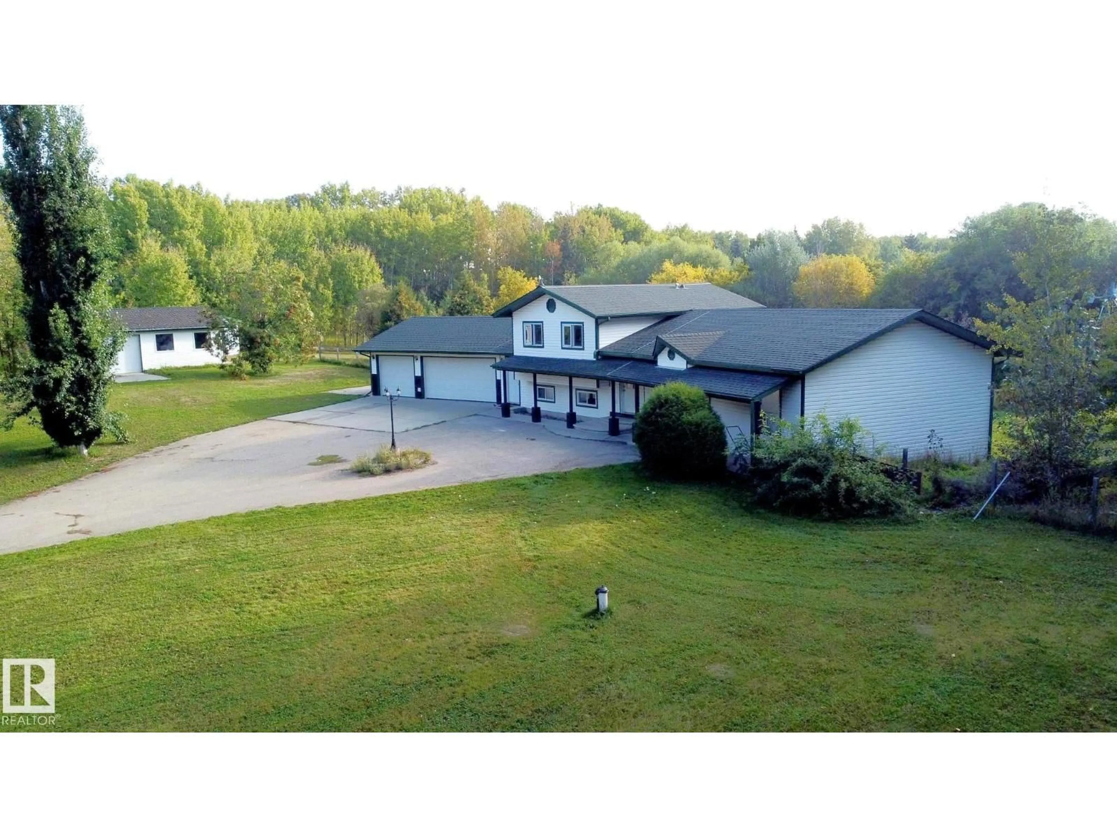 A pic from outside/outdoor area/front of a property/back of a property/a pic from drone, building for #101 - 52502 RGE ROAD 25, Rural Parkland County Alberta T7Y2M2