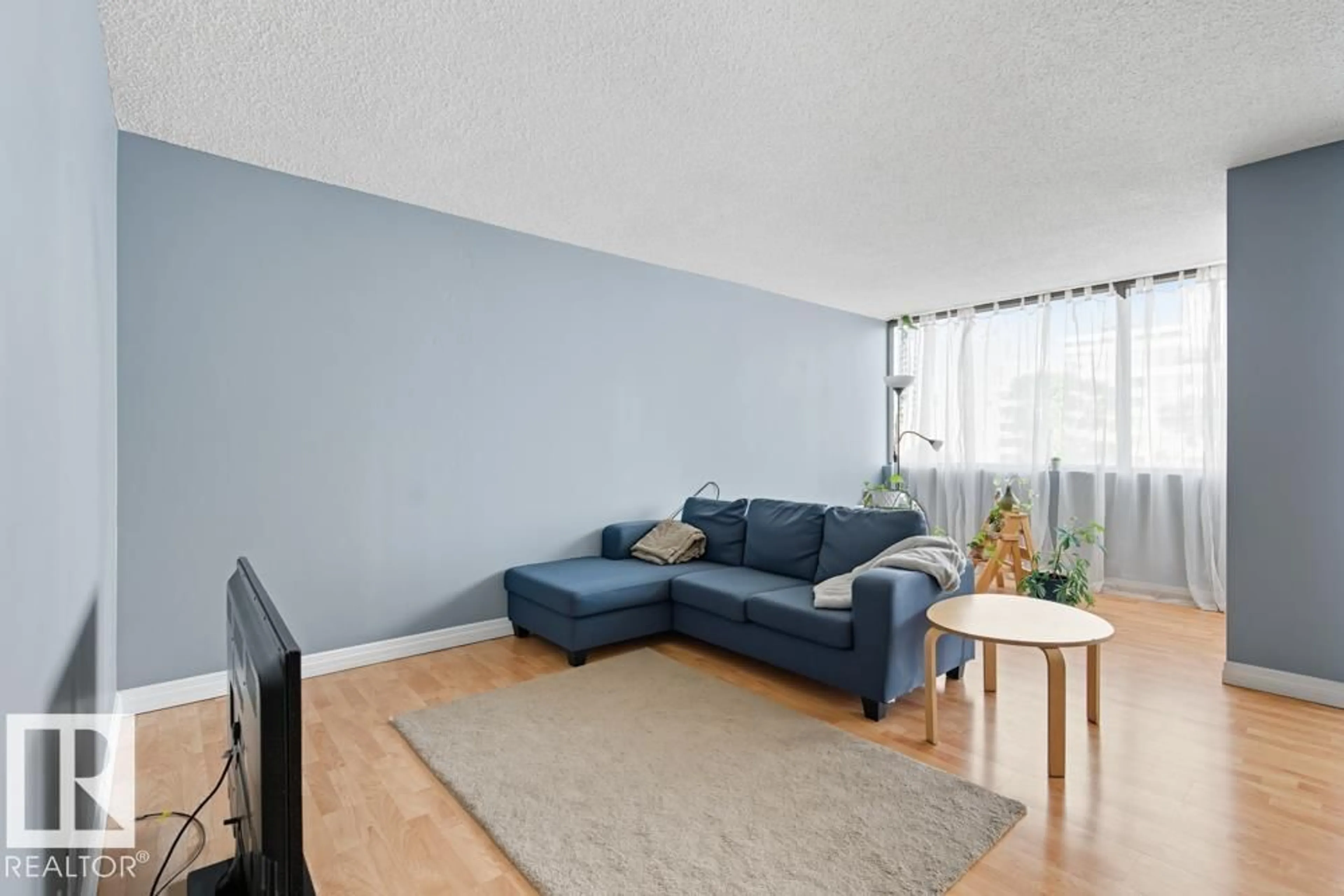 Living room with furniture, wood/laminate floor for 504 - 10025 113 ST, Edmonton Alberta T5K2K8