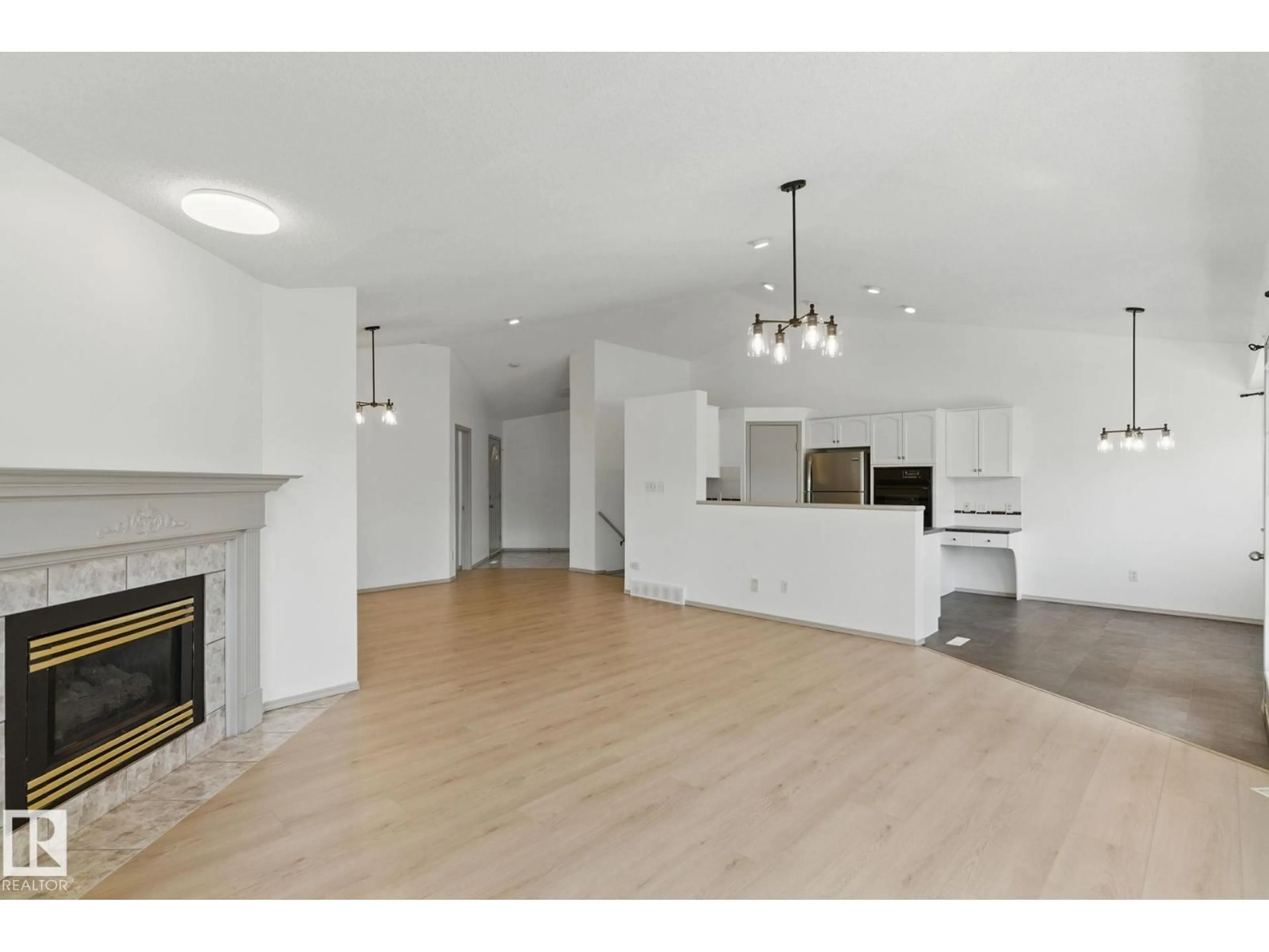Open concept kitchen, wood/laminate floor for 9971 178 AV, Edmonton Alberta T5X5X2