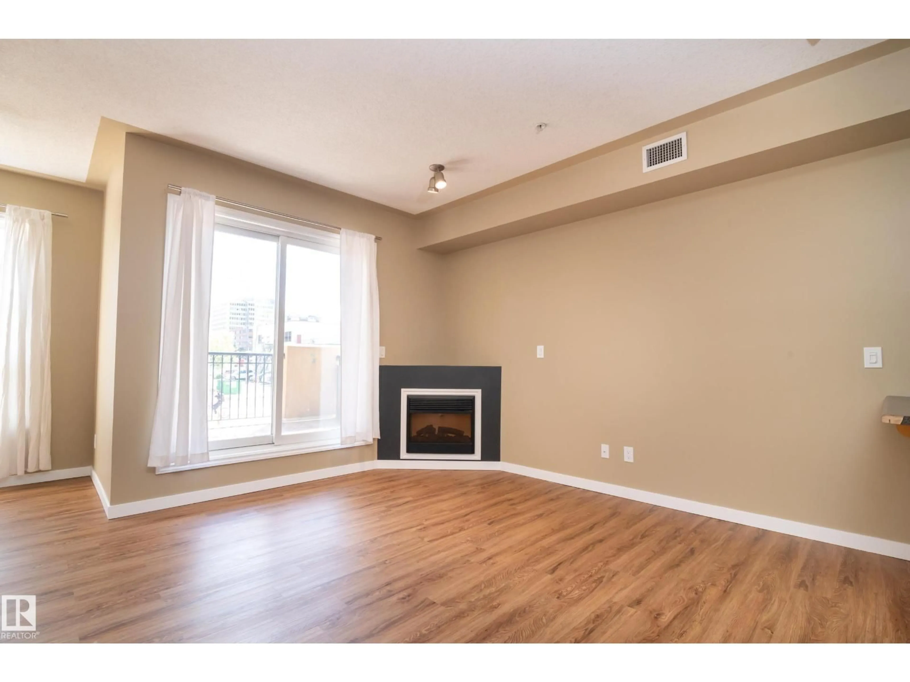 Living room with furniture, wood/laminate floor for 201 - 10606 102 AV NW, Edmonton Alberta T5J5E9