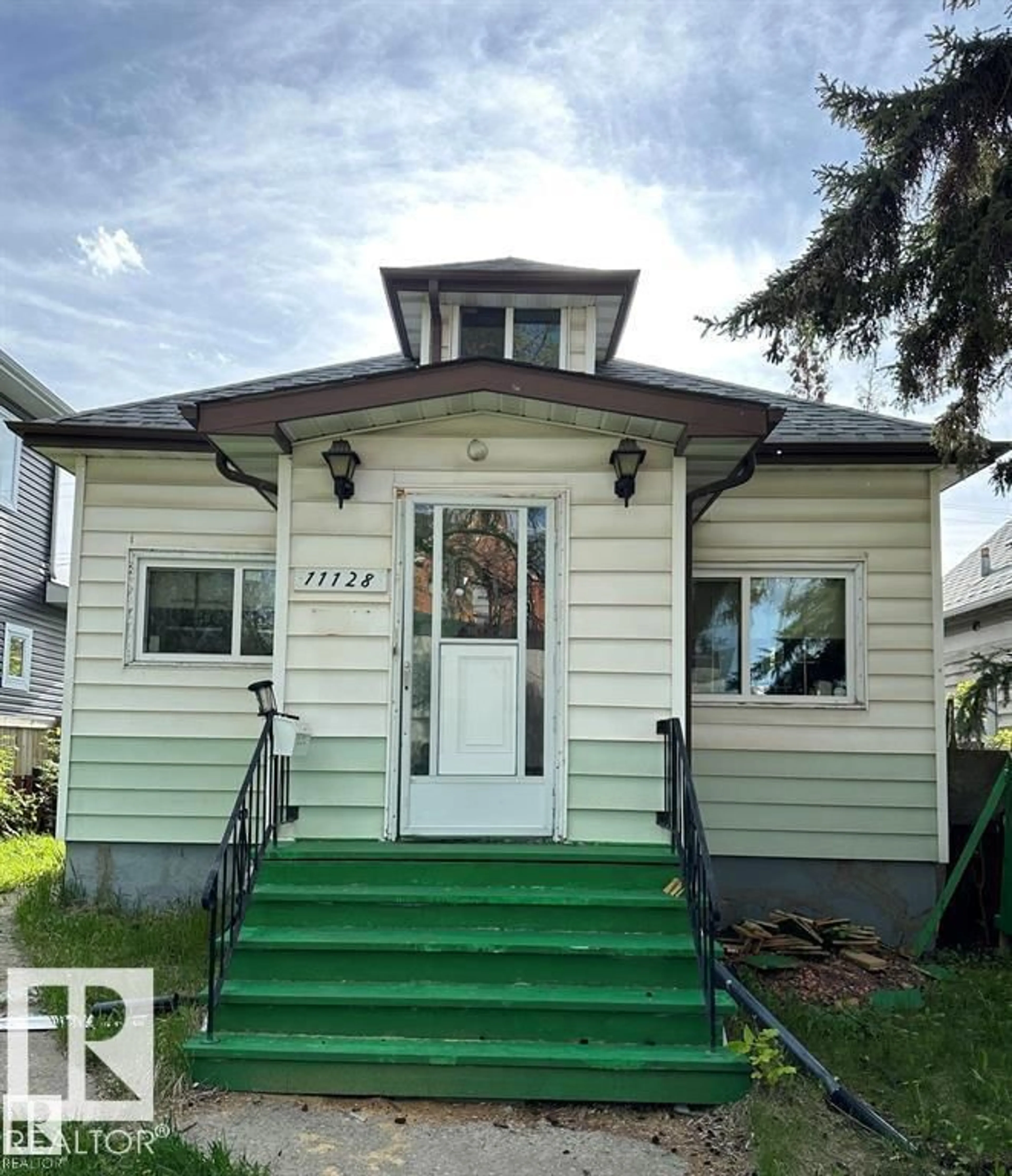 Home with vinyl exterior material, street for 11128 95A ST NW, Edmonton Alberta T5G1N7