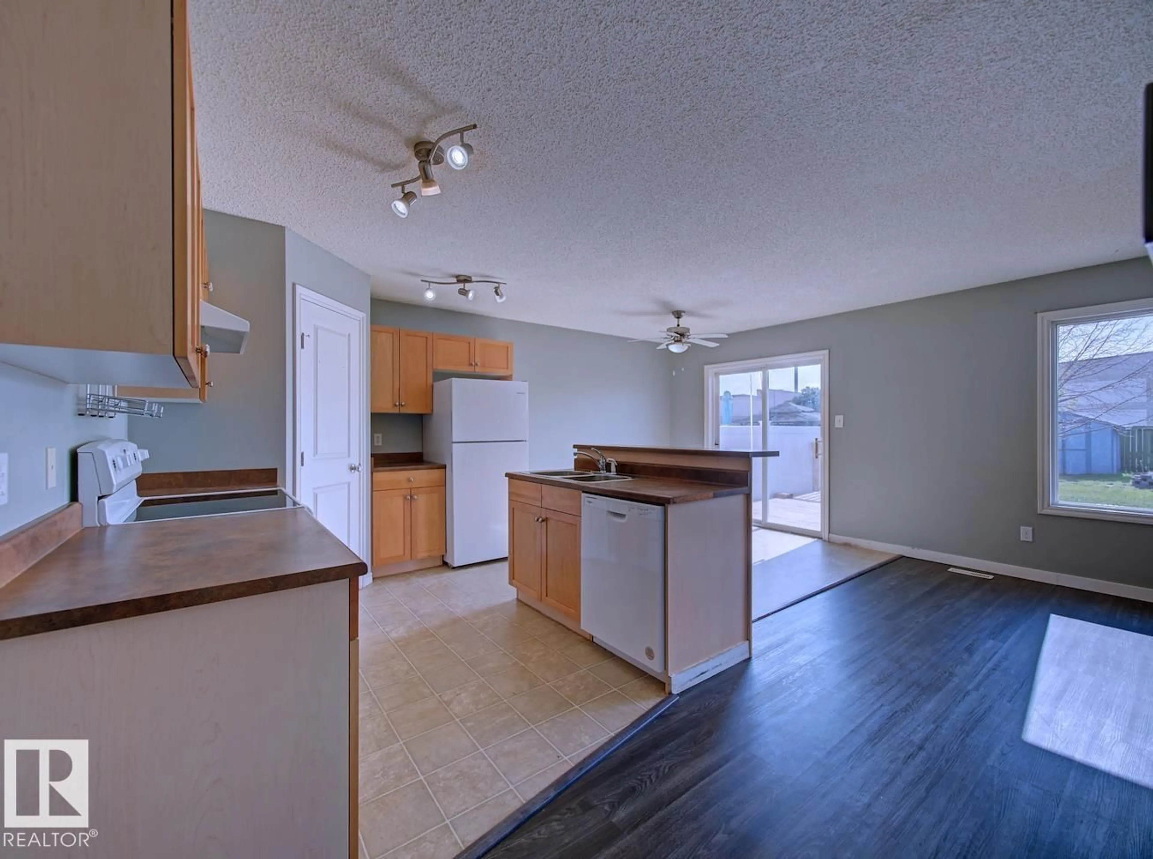 Open concept kitchen, wood/laminate floor for 147 WESTWOOD LN, Fort Saskatchewan Alberta T0B4N8