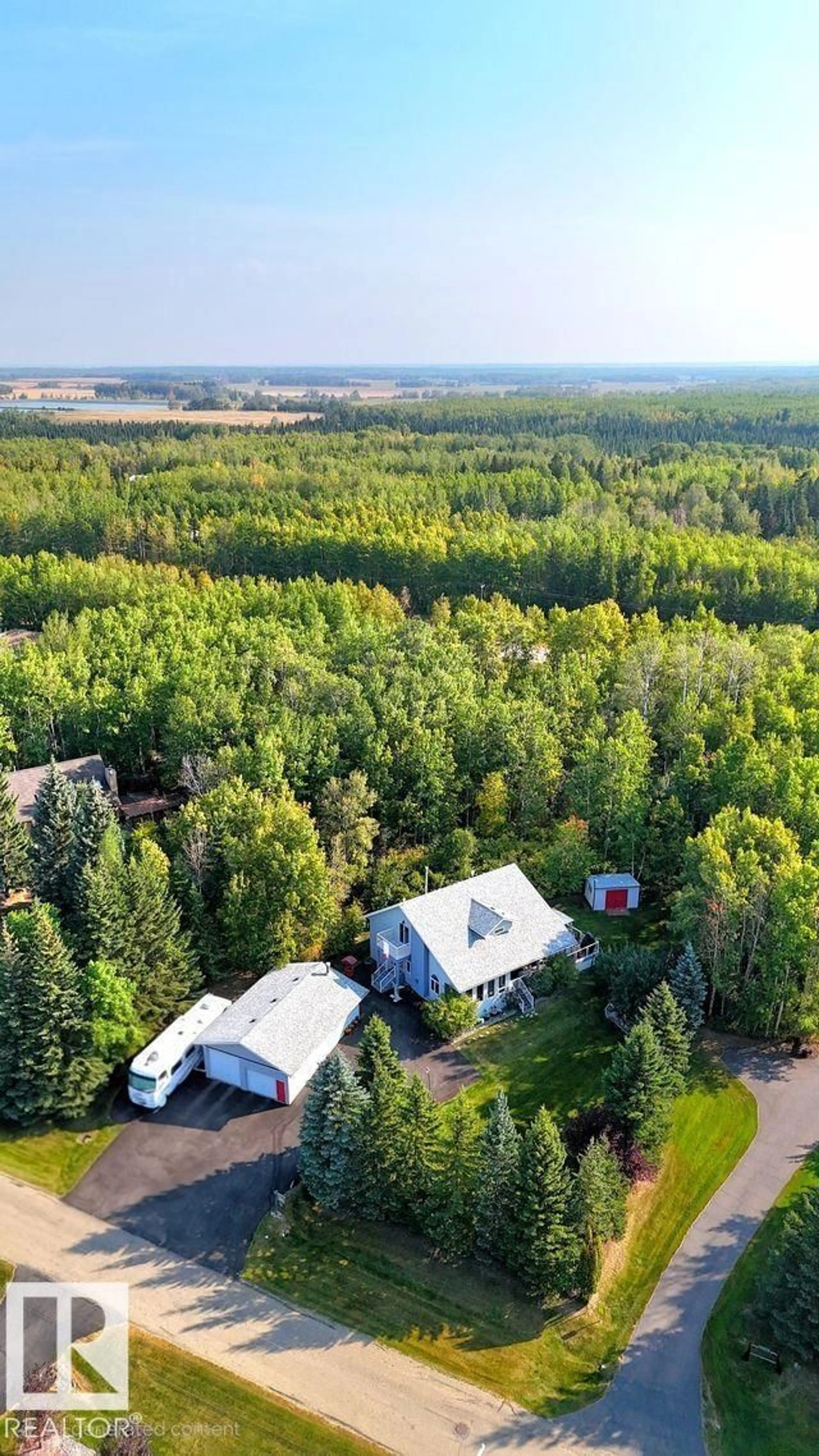 A pic from outside/outdoor area/front of a property/back of a property/a pic from drone, forest/trees view for 5402 32 ST, Rural Wetaskiwin County Alberta T0C2C0