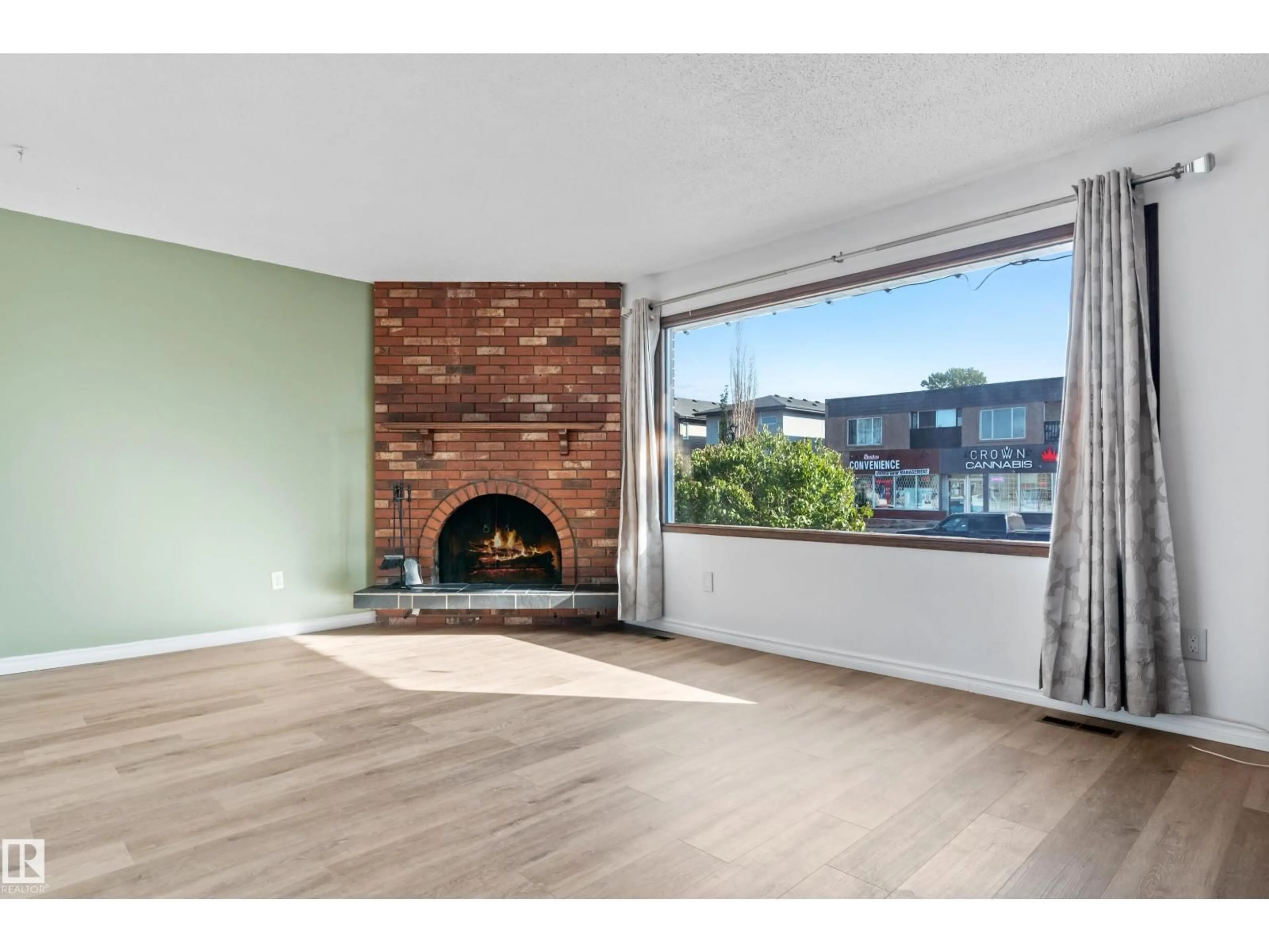 Living room with furniture, wood/laminate floor for 9558 76 AV, Edmonton Alberta T6C0K2