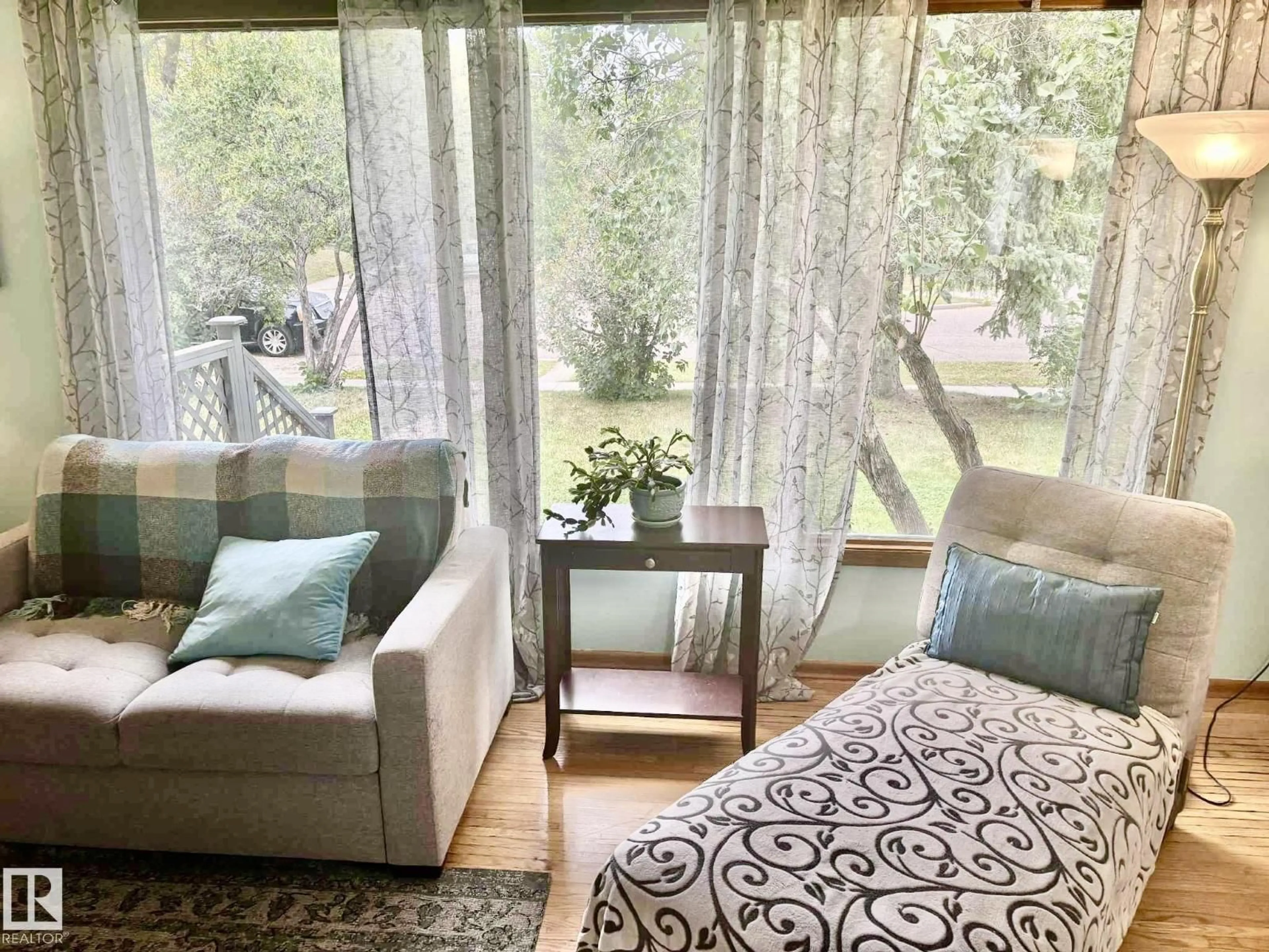 Living room with furniture, wood/laminate floor for 14443 107A AV, Edmonton Alberta T5N1G3