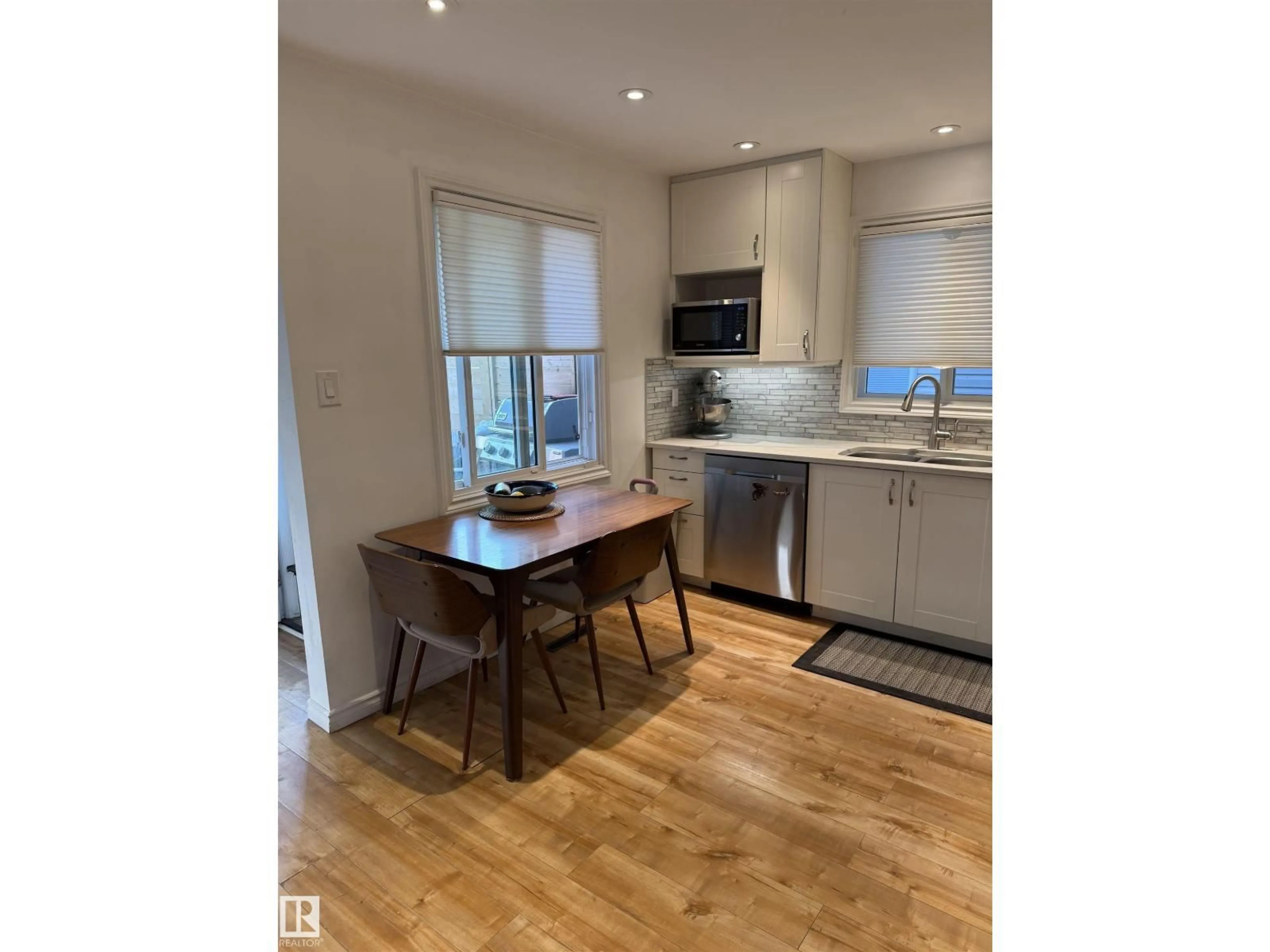 Open concept kitchen, wood/laminate floor for 12131 65 ST, Edmonton Alberta T5W4L6