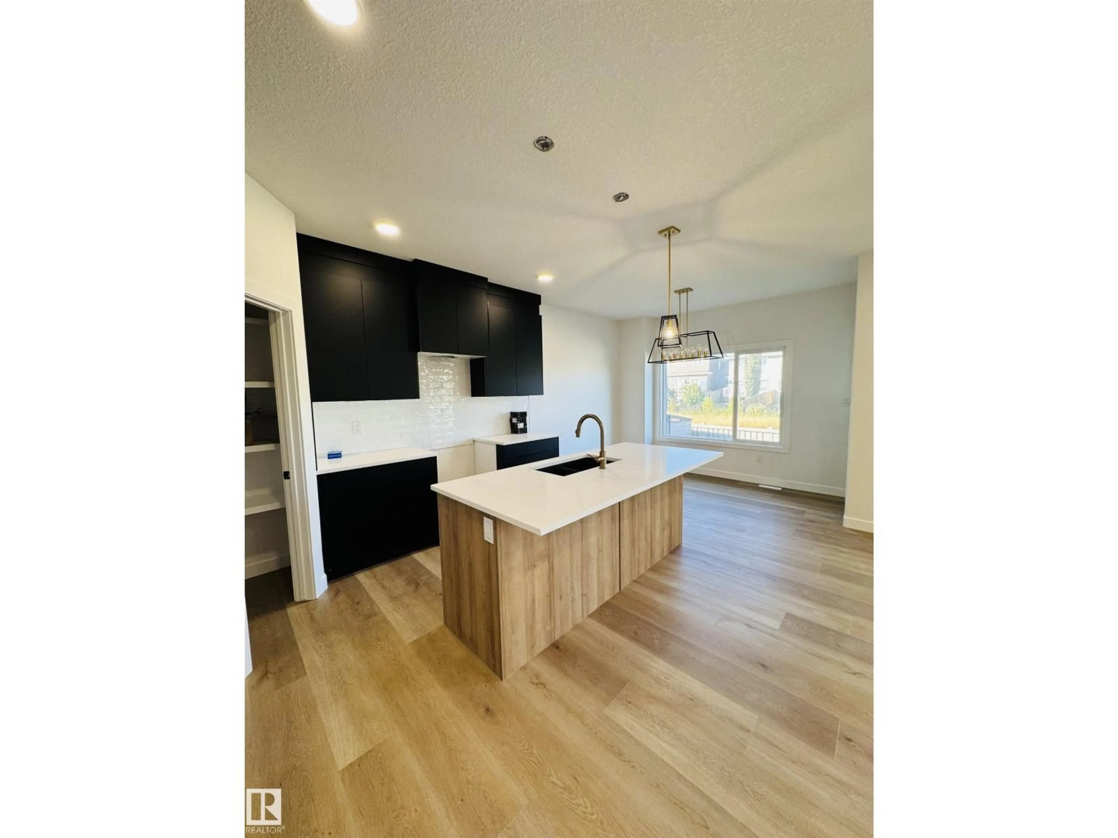 Open concept kitchen, wood/laminate floor for 3174 MAGPIE WAY, Edmonton Alberta T5S0K9