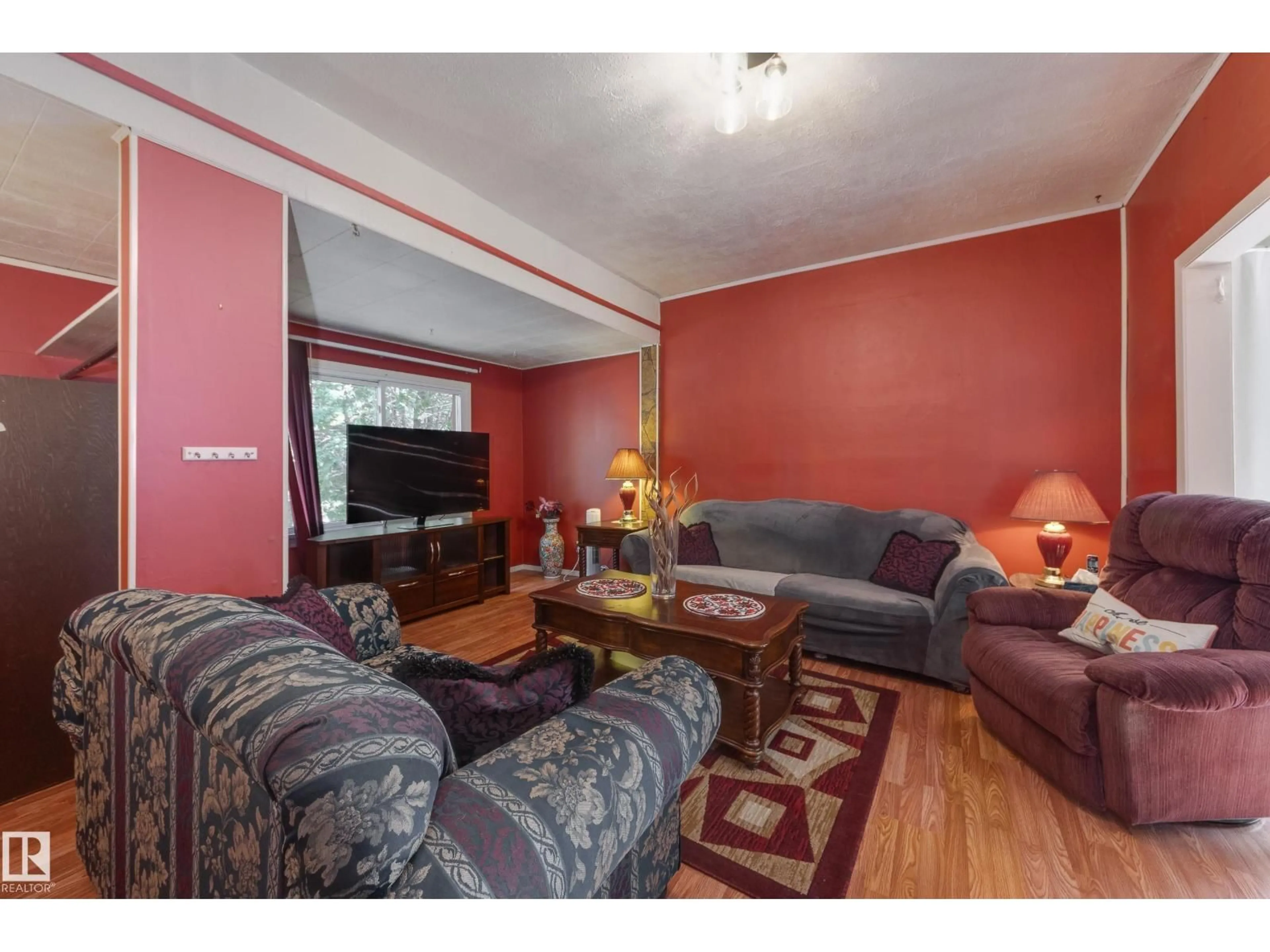 Living room with furniture, wood/laminate floor for NW - 12126 39 ST, Edmonton Alberta T5W2K1