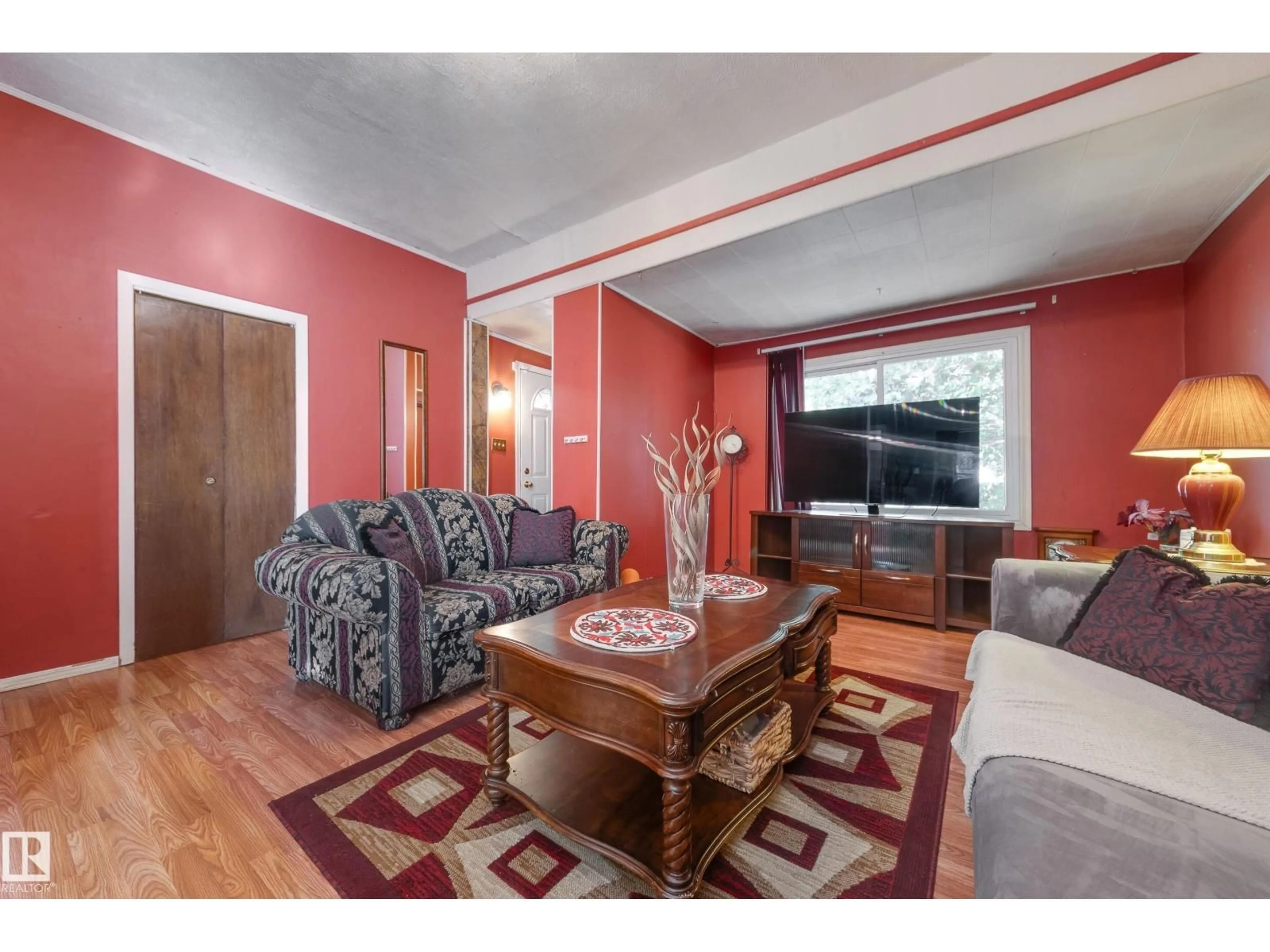 Living room with furniture, wood/laminate floor for NW - 12126 39 ST, Edmonton Alberta T5W2K1