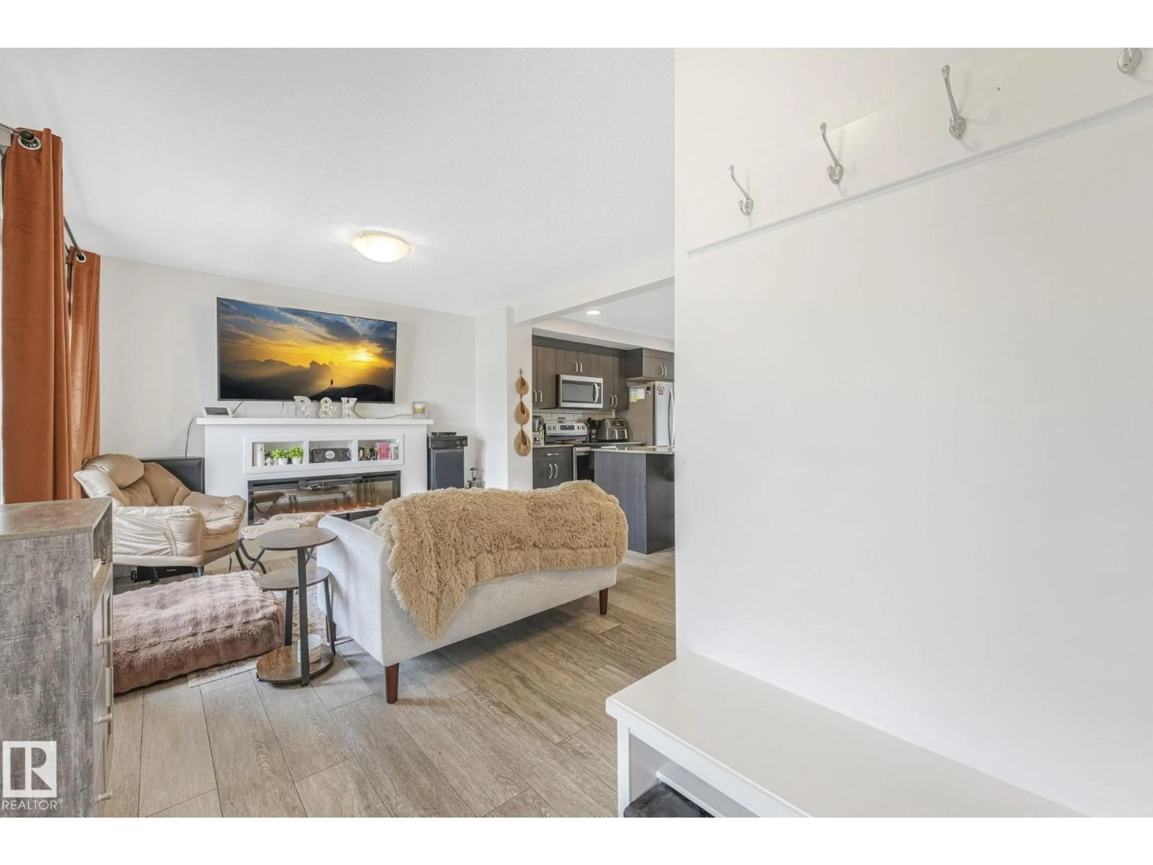 Living room with furniture, wood/laminate floor for 1094 CY BECKER RD, Edmonton Alberta T5Y3Z9