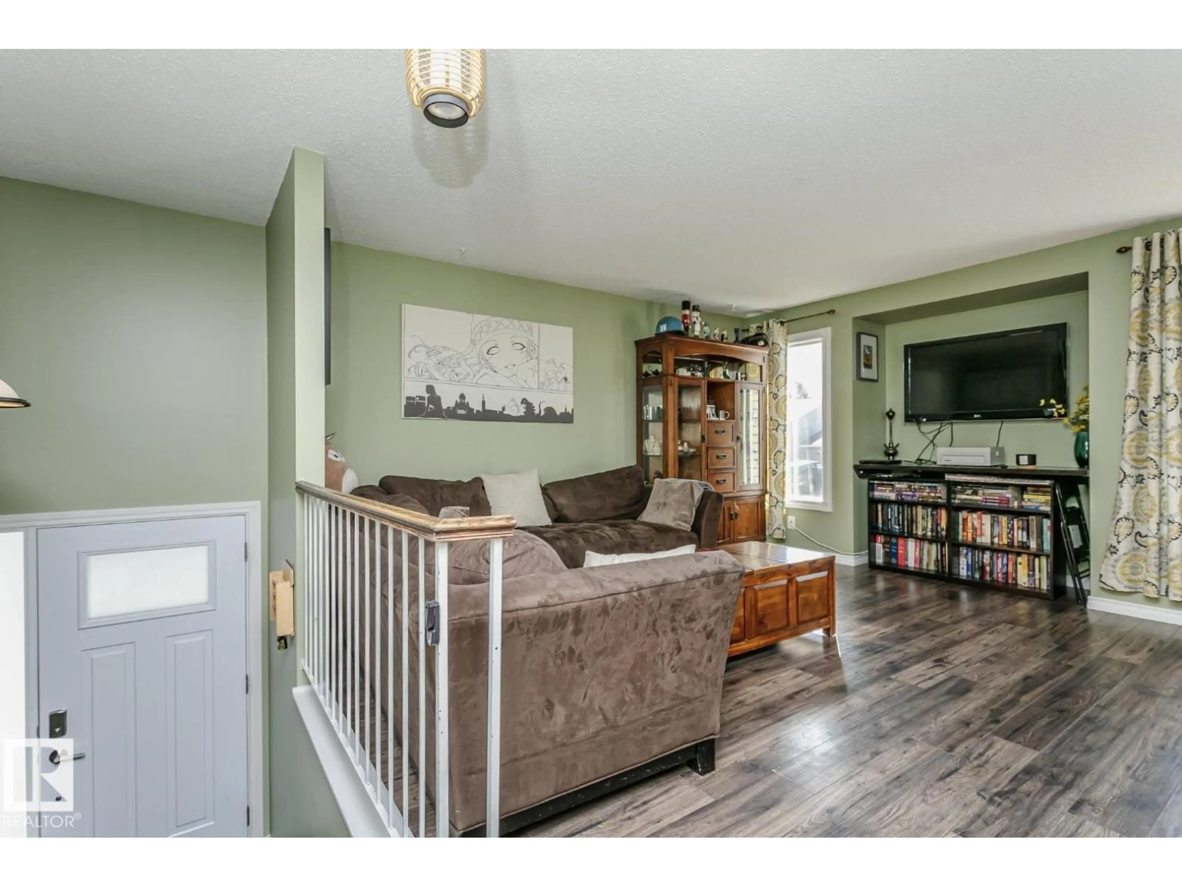 Living room with furniture, wood/laminate floor for 3520 33 AV, Edmonton Alberta T6L5G6