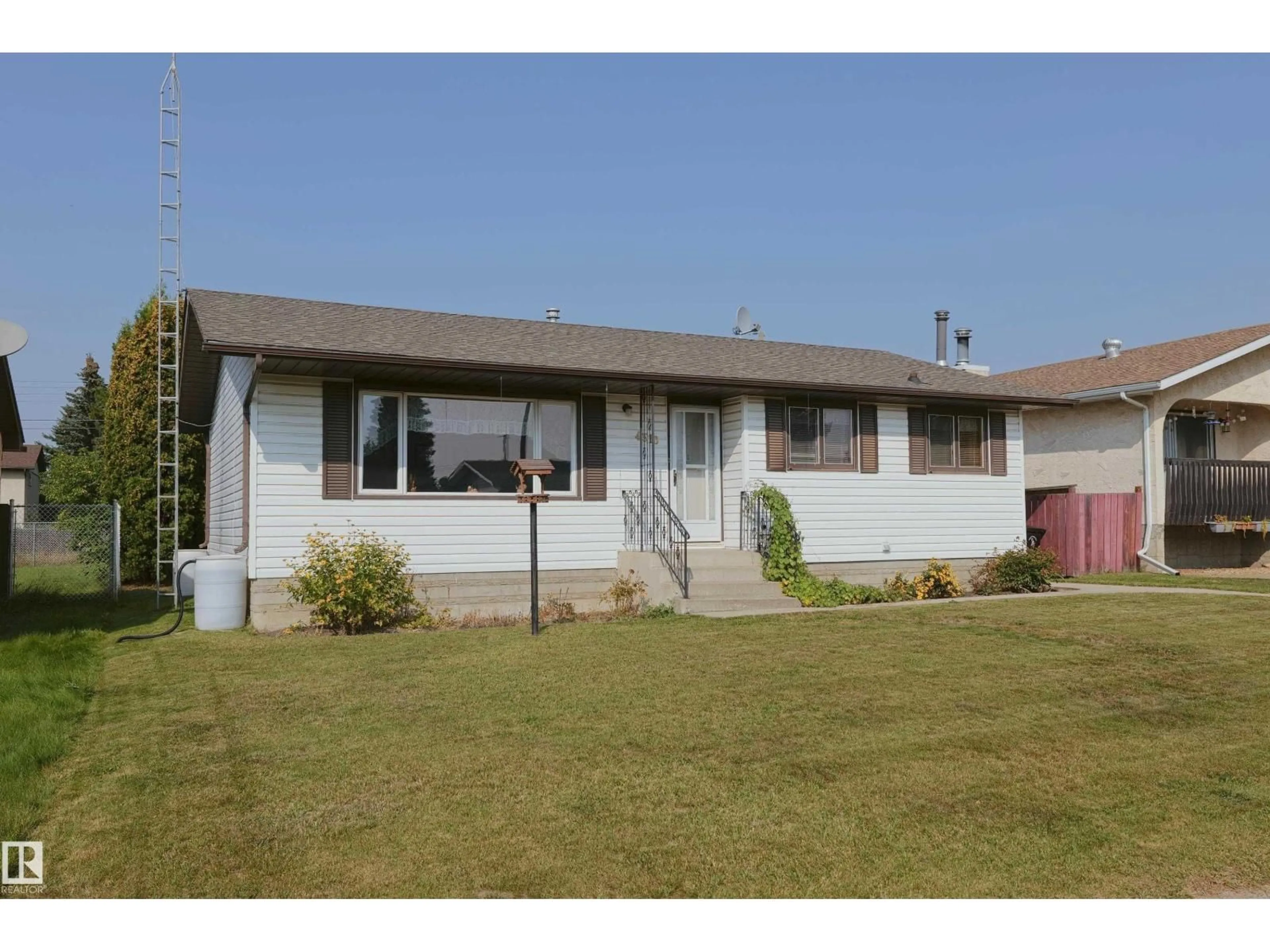 Home with vinyl exterior material, street for 4310 56 AVENUE, Barrhead Alberta T7N1K2