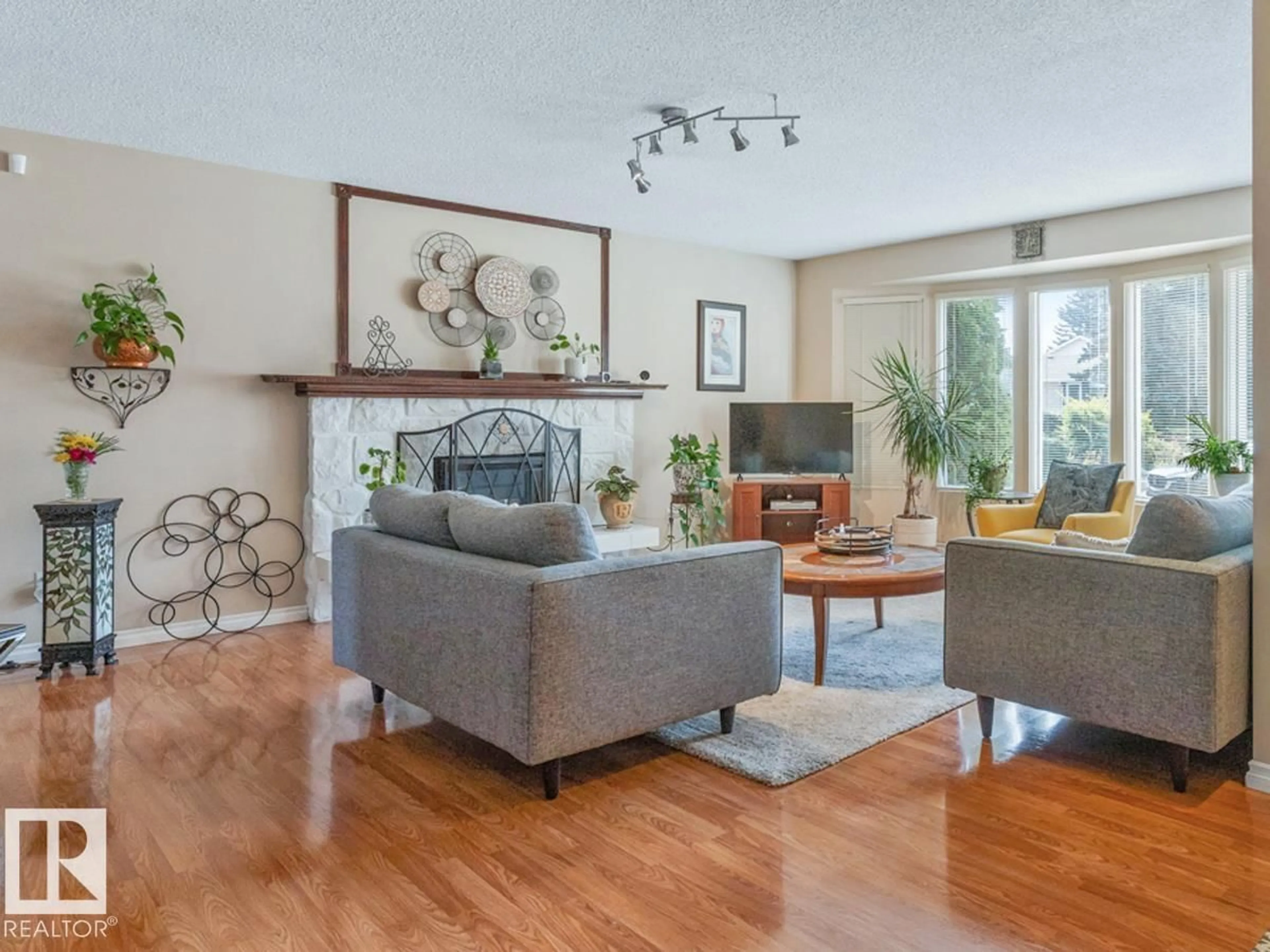 Living room with furniture, wood/laminate floor for 4359 68 ST, Edmonton Alberta T5K0T7