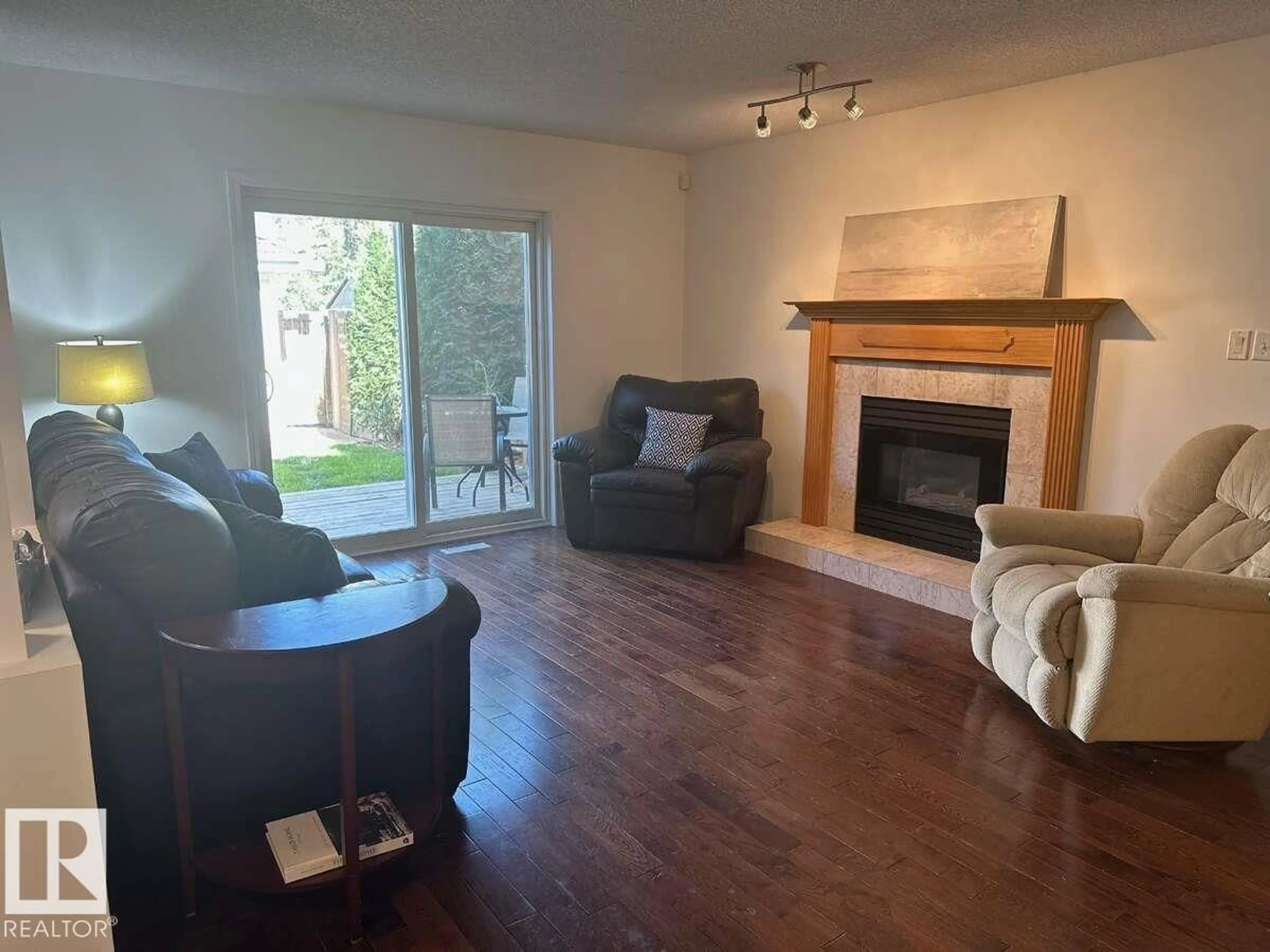 Living room with furniture, wood/laminate floor for 10020 97 AV, Edmonton Alberta T5K0B1