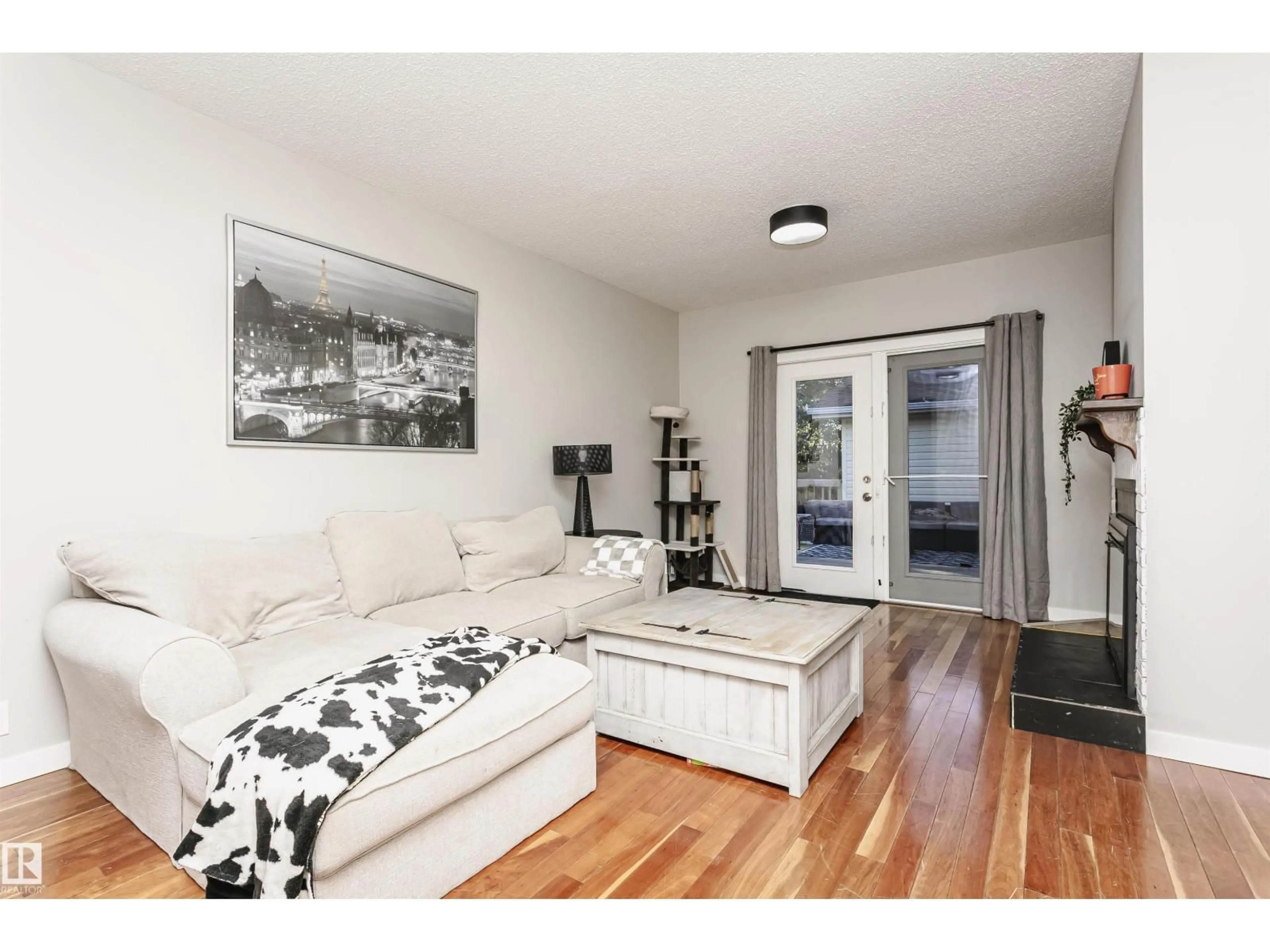 Living room with furniture, wood/laminate floor for NW - 18331 68 AV, Edmonton Alberta T5T2H5