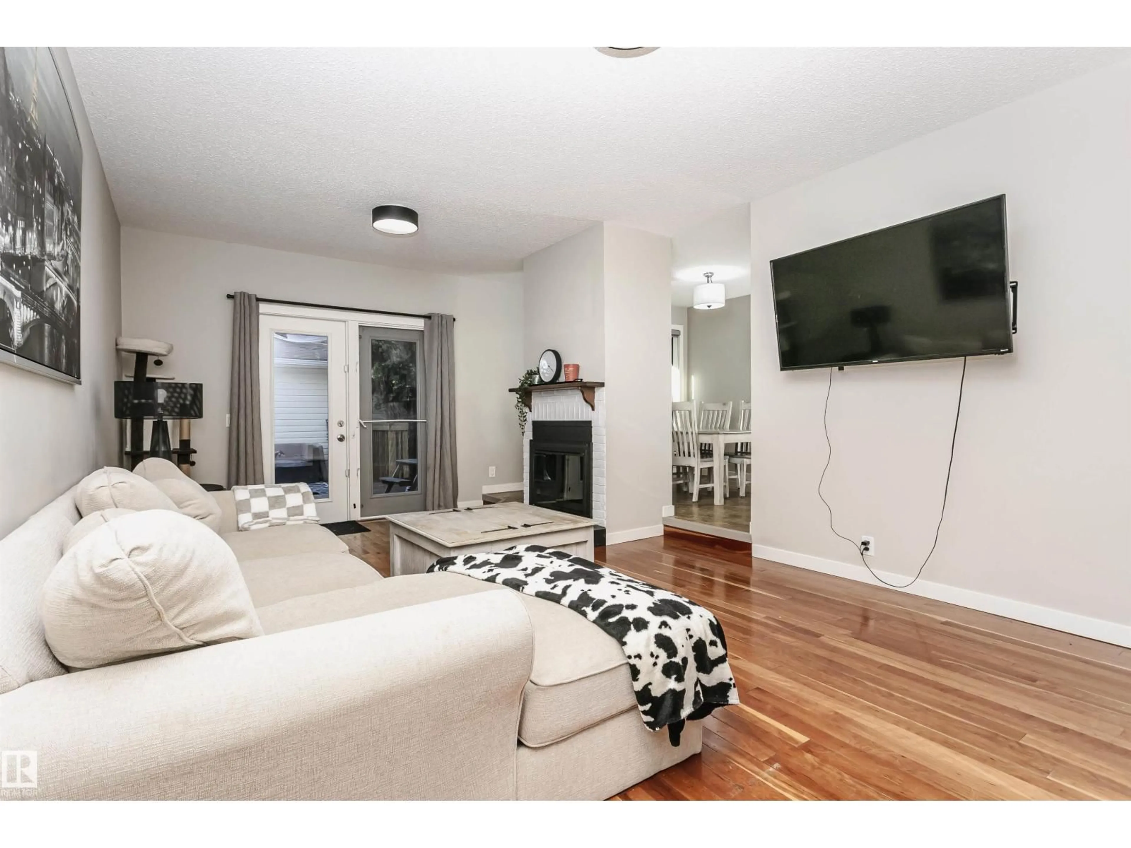 Living room with furniture, wood/laminate floor for NW - 18331 68 AV, Edmonton Alberta T5T2H5