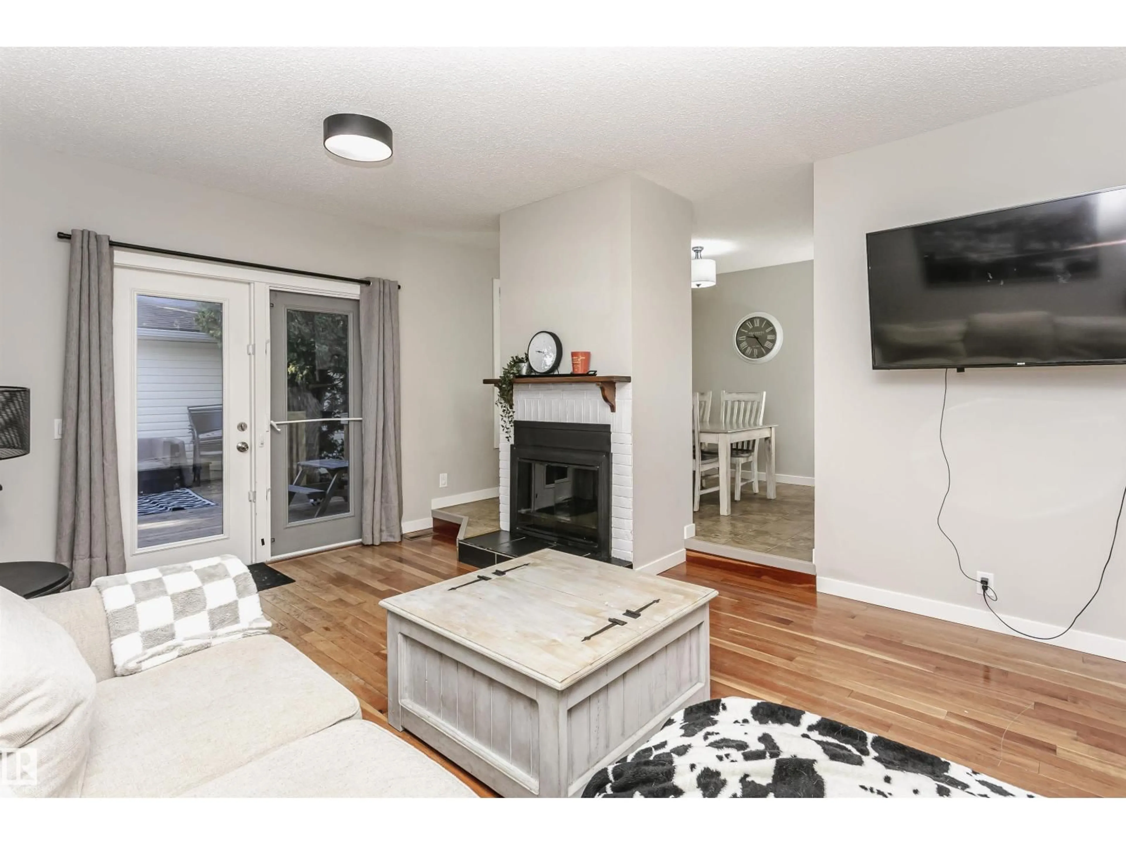 Living room with furniture, wood/laminate floor for NW - 18331 68 AV, Edmonton Alberta T5T2H5