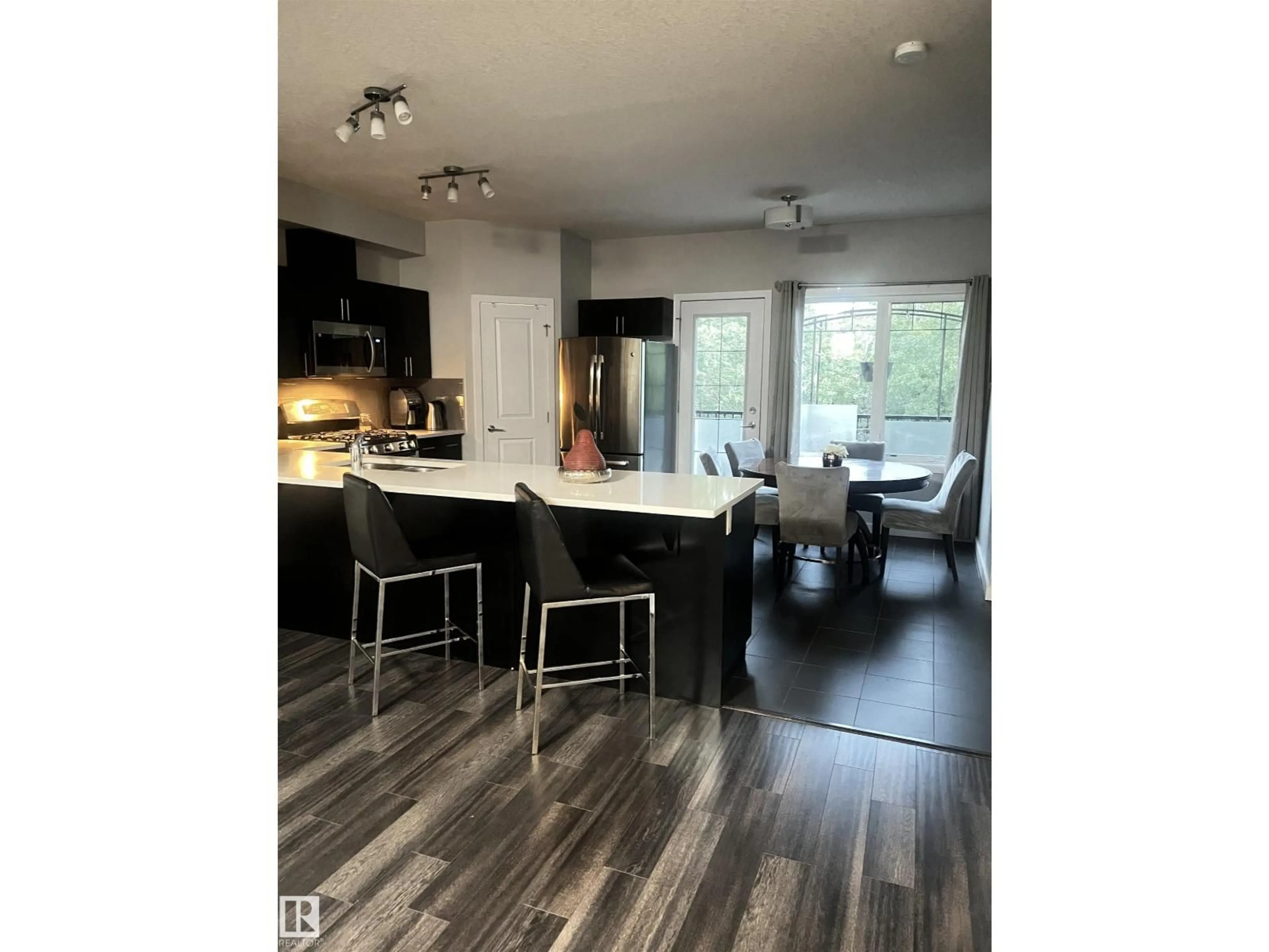 Open concept kitchen, wood/laminate floor for 22 5873 MULLEN PL, Edmonton Alberta T6R0T5
