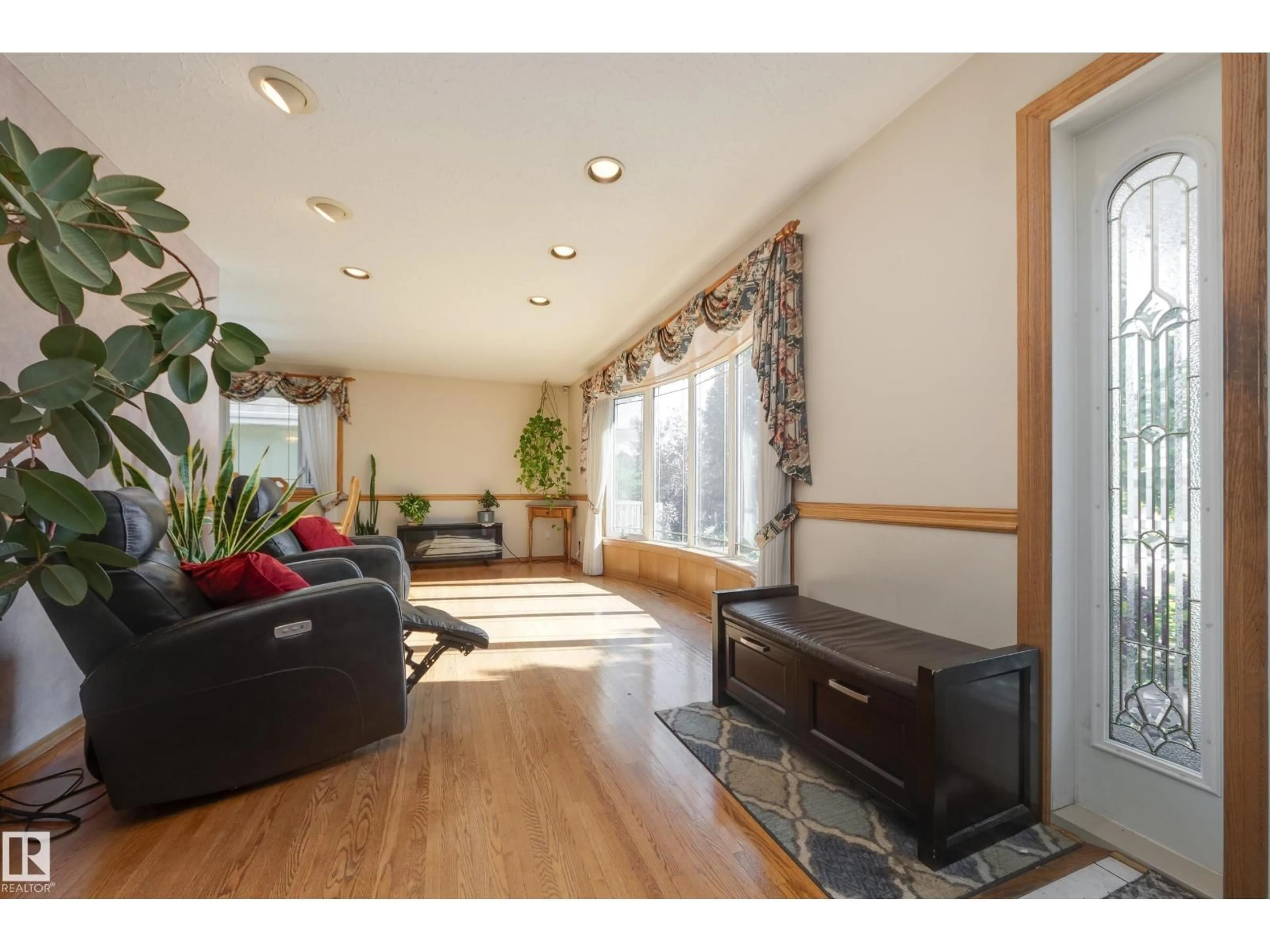 Living room with furniture, wood/laminate floor for 7512 129A AV NW, Edmonton Alberta T5C1W9