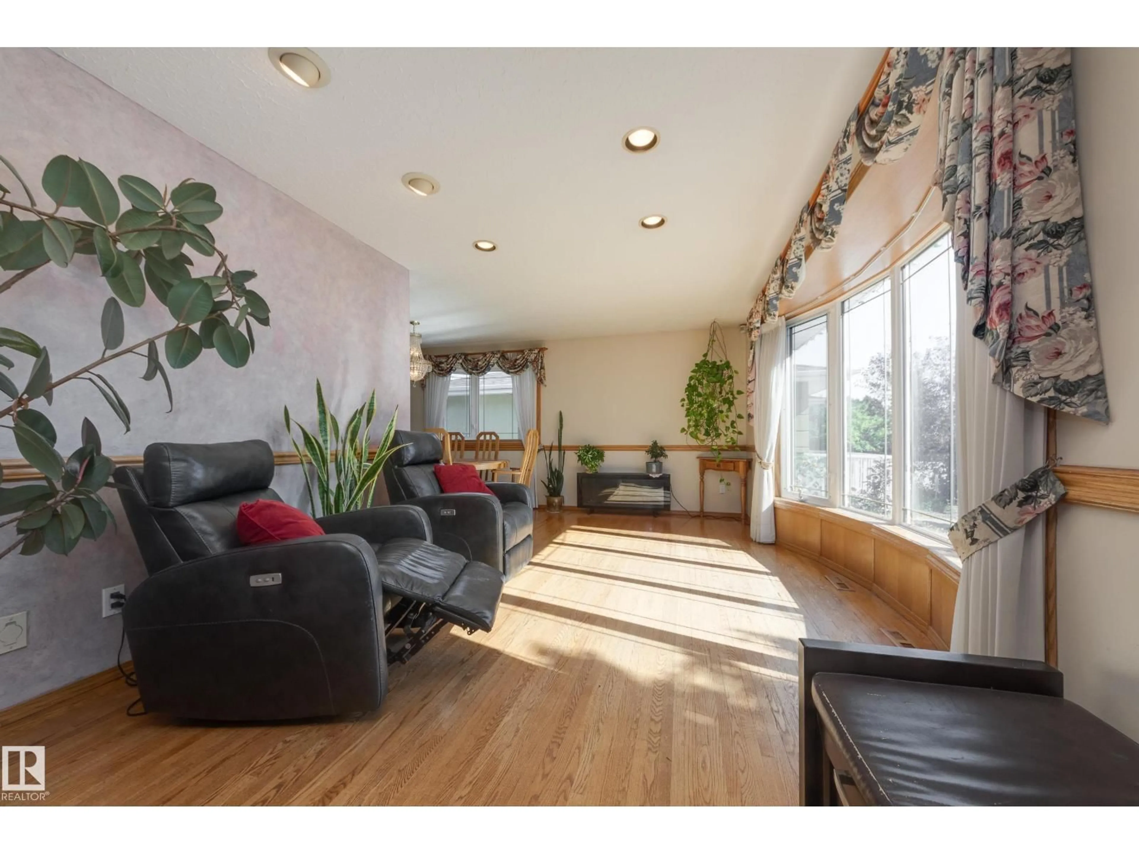 Living room with furniture, wood/laminate floor for 7512 129A AV NW, Edmonton Alberta T5C1W9