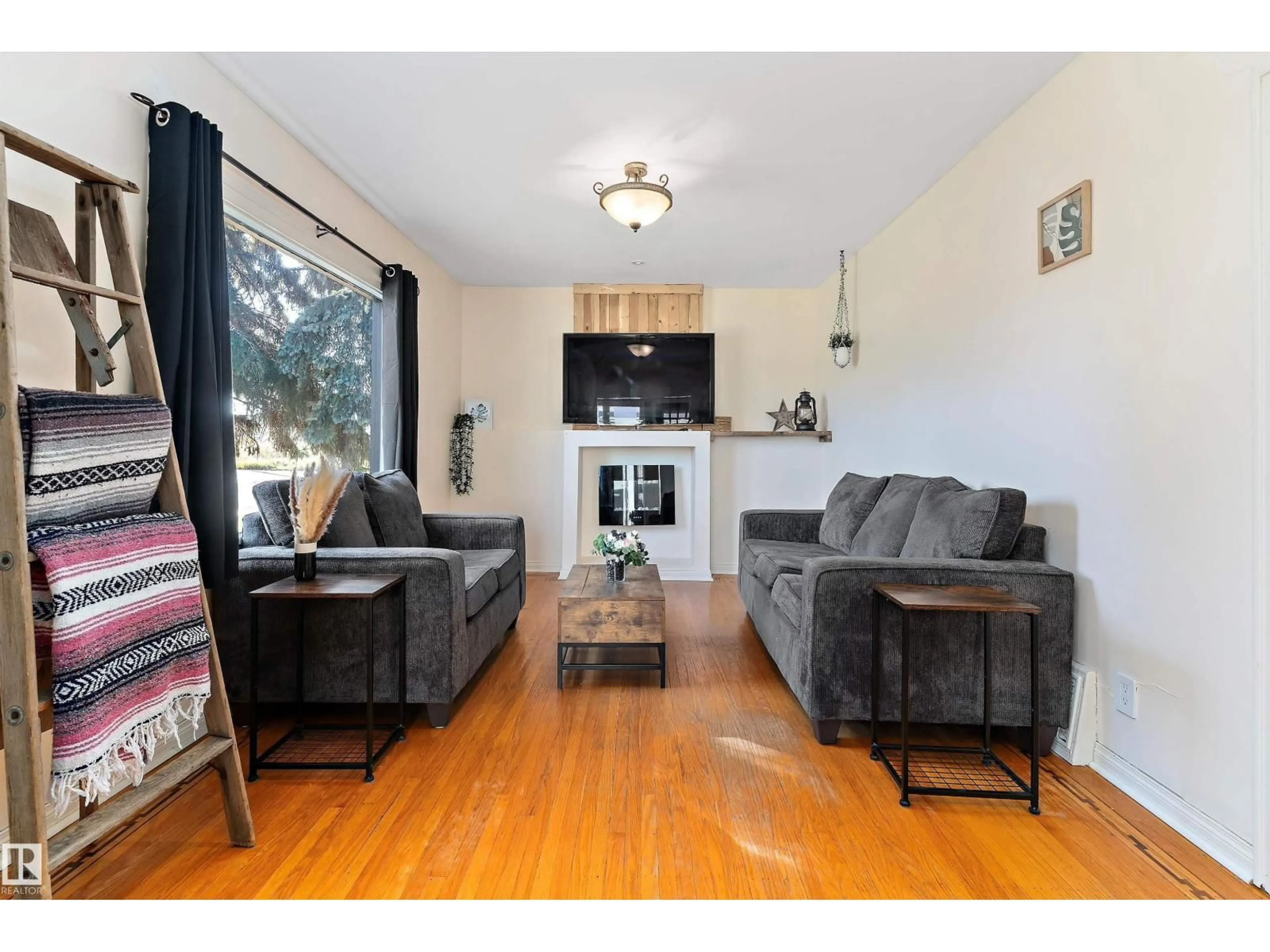 Living room with furniture, wood/laminate floor for 12712 130 ST, Edmonton Alberta T5L1L2