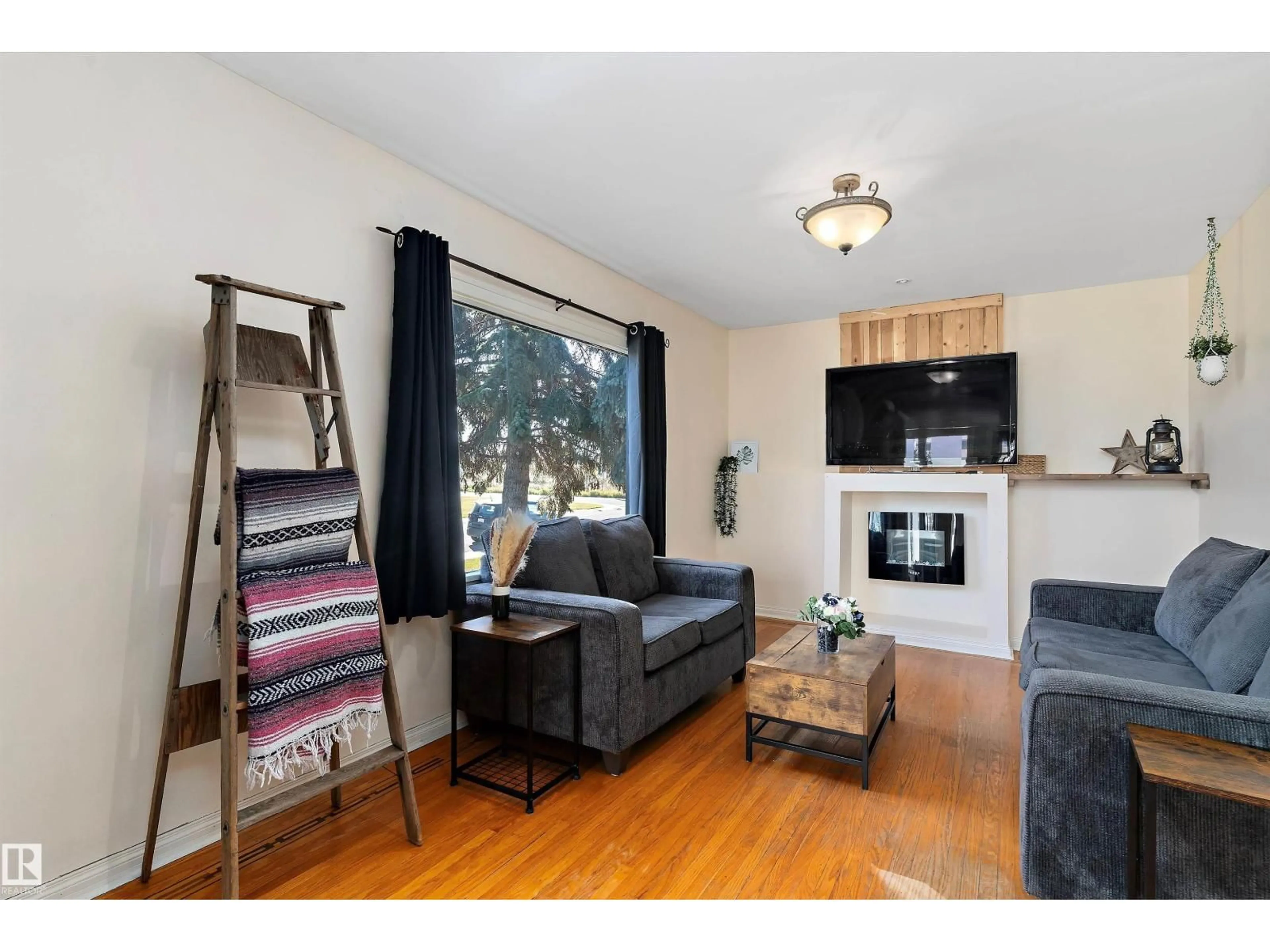 Living room with furniture, wood/laminate floor for 12712 130 ST, Edmonton Alberta T5L1L2