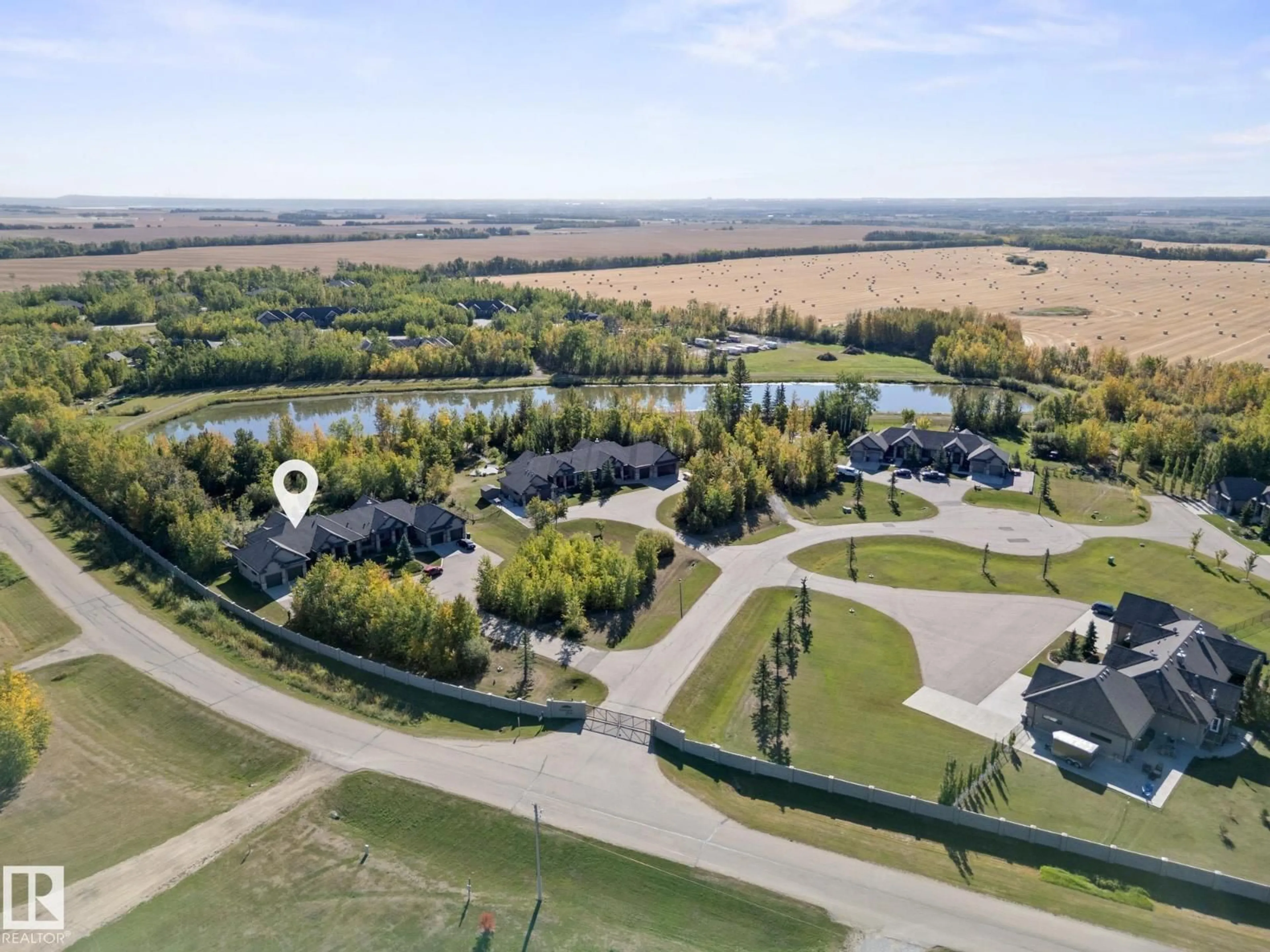 A pic from outside/outdoor area/front of a property/back of a property/a pic from drone, water/lake/river/ocean view for 9B - 53522 RGE ROAD 272, Rural Parkland County Alberta T7X3M5