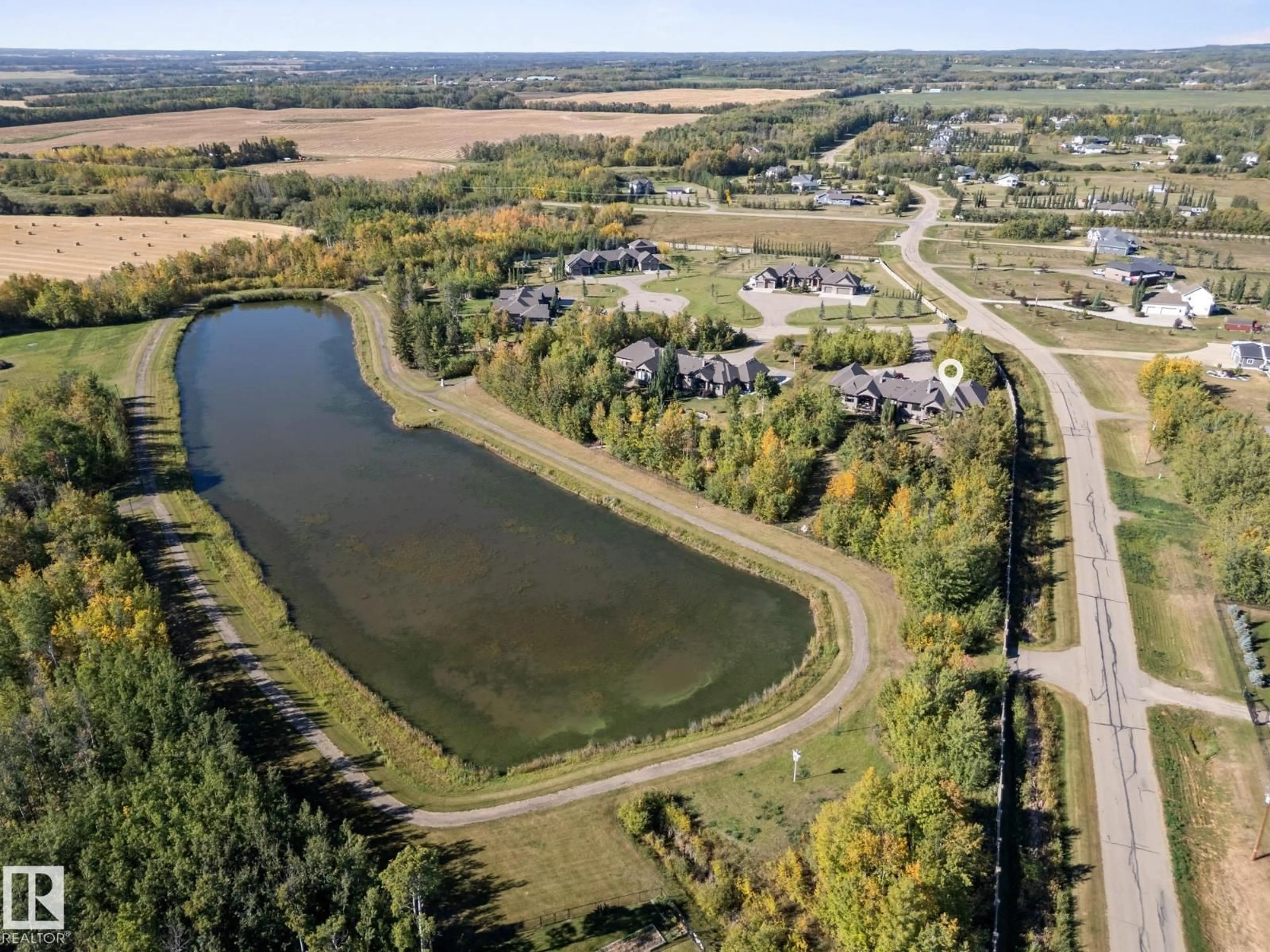 A pic from outside/outdoor area/front of a property/back of a property/a pic from drone, water/lake/river/ocean view for 9B - 53522 RGE ROAD 272, Rural Parkland County Alberta T7X3M5