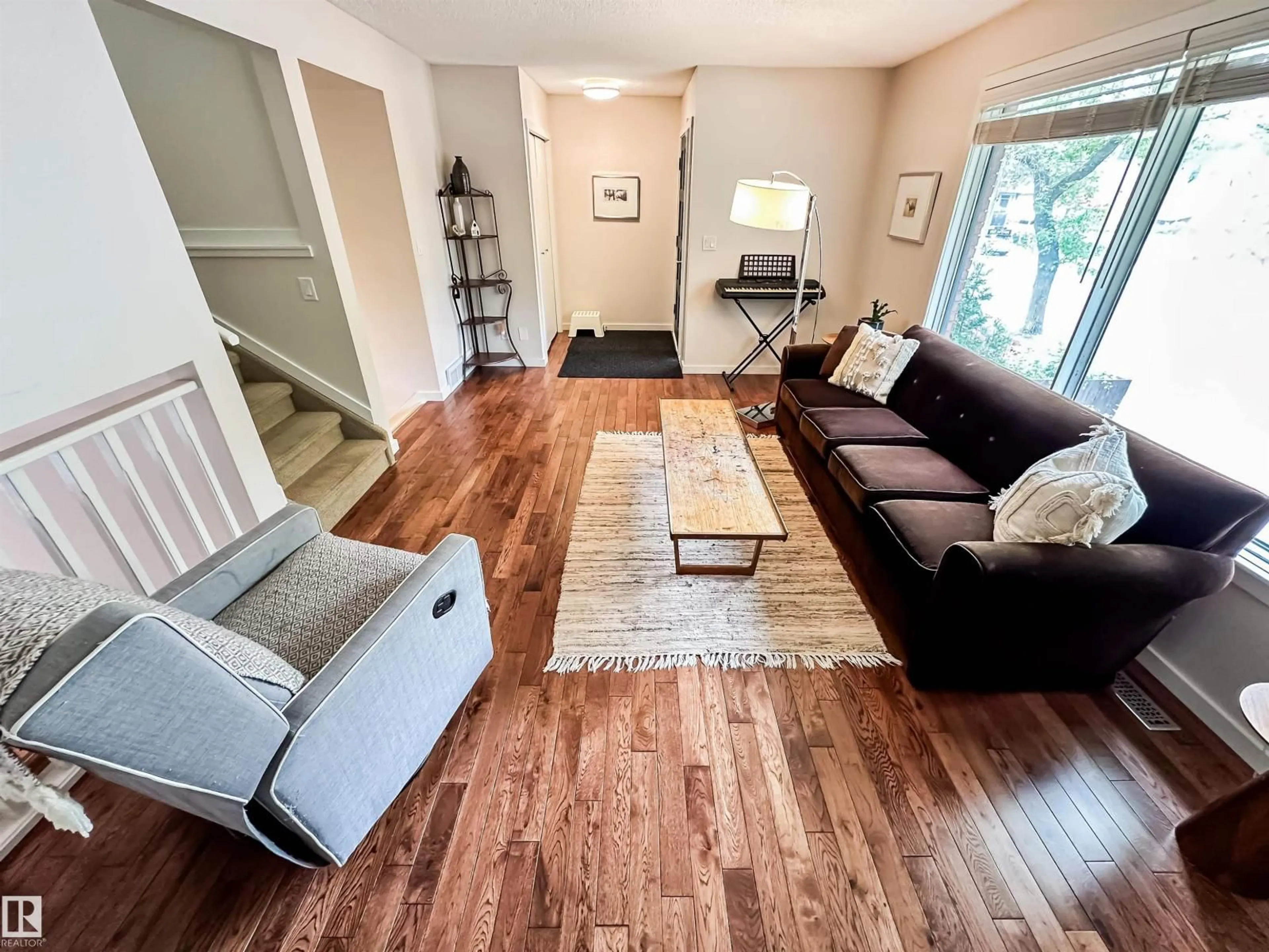 Living room with furniture, wood/laminate floor for 12005 90 ST, Edmonton Alberta T5B3Z2
