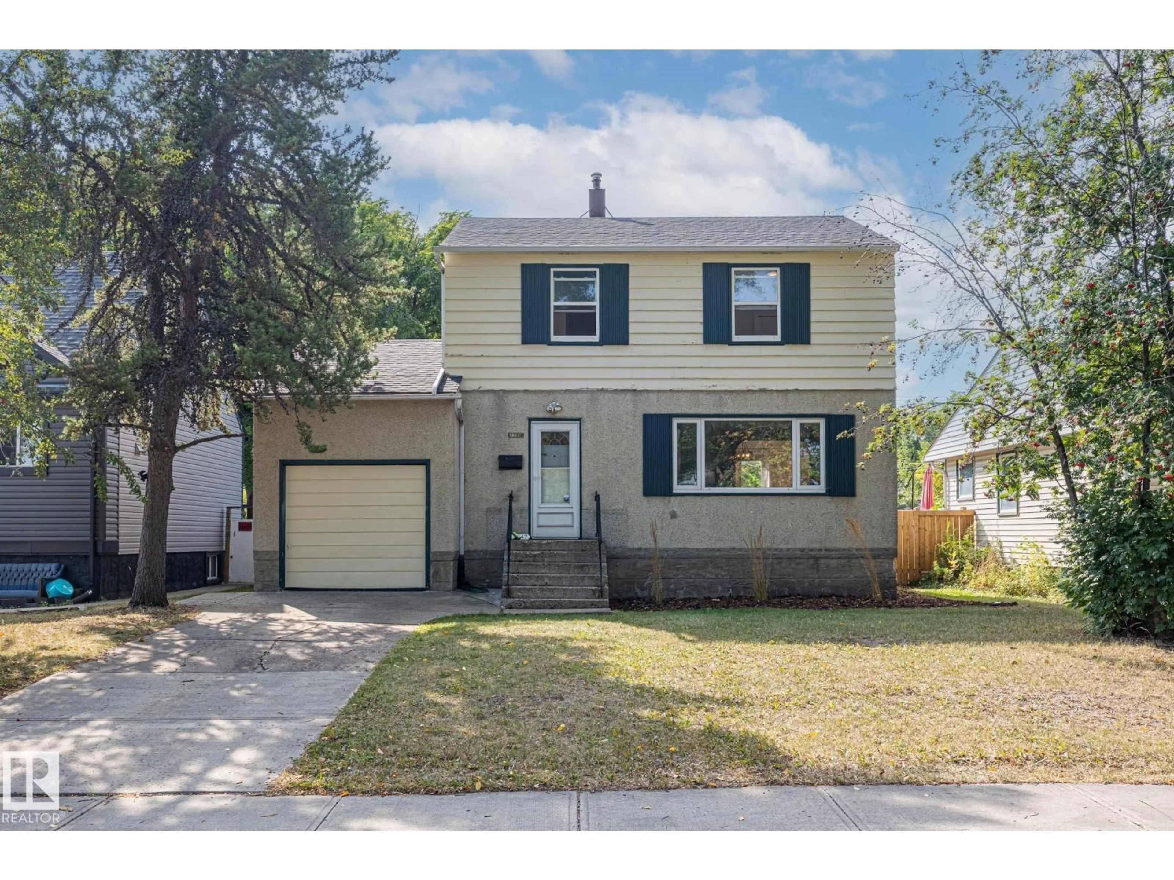 Home with vinyl exterior material, street for 13647 122 AV, Edmonton Alberta T5L2W1