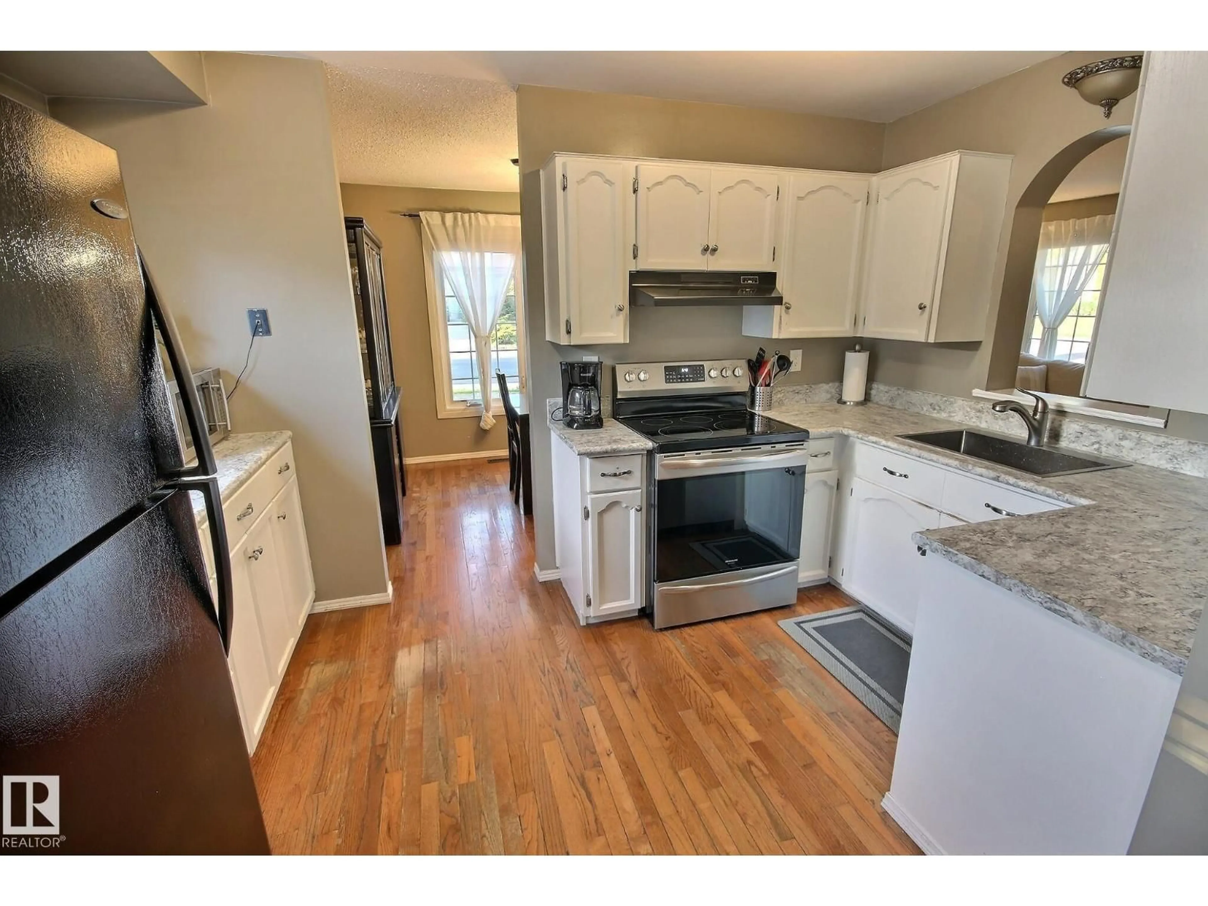 Open concept kitchen, wood/laminate floor for 121 WILLIAM HUSTLER CR, Edmonton Alberta T5A4C1
