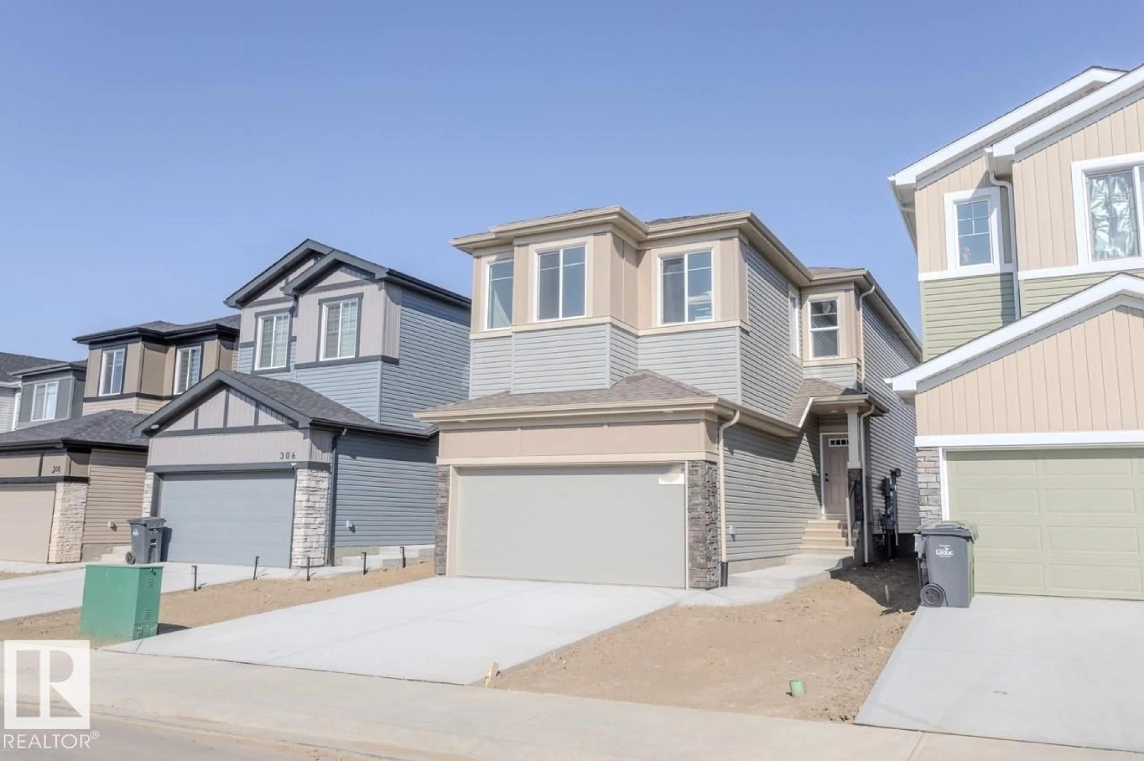 Home with vinyl exterior material, street for 304 JUNIPER CV, Leduc Alberta T9E1S7